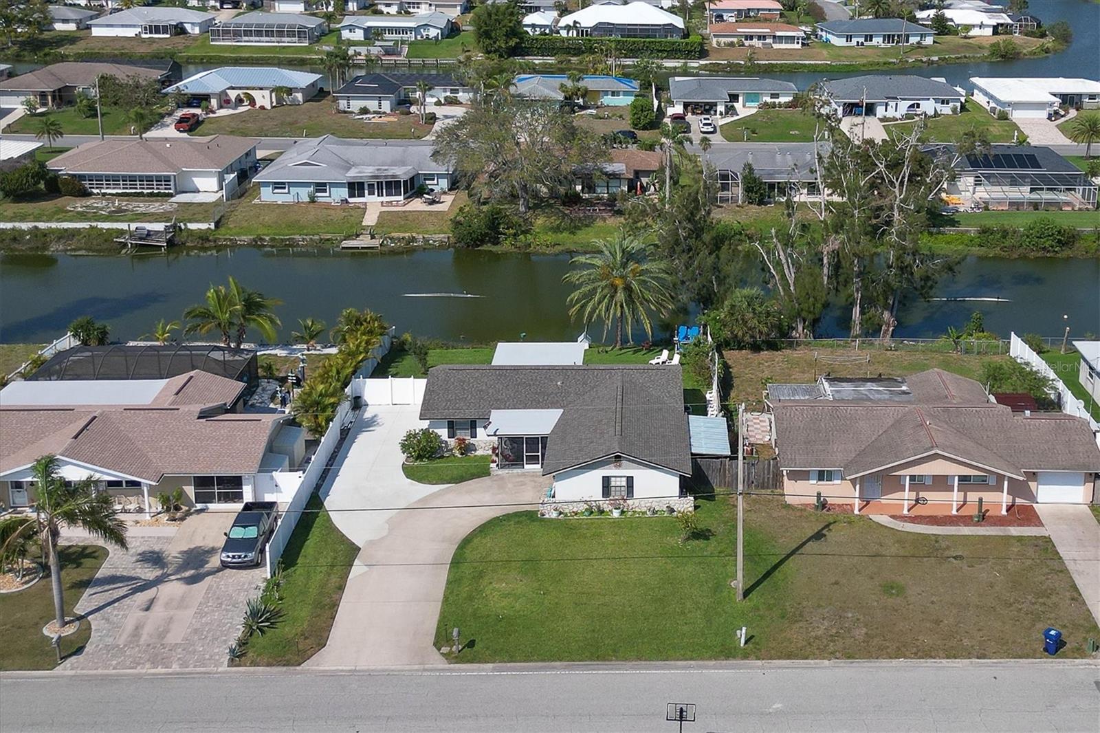 Awesome opportunity for this three-bedroom, two-bath Venice Gardens home with incredible water views. Generous-sized master bedroom with updated master bath and two guest bedrooms on the other side of the house to give your guests ample privacy. Spacious great room adjacent to the dining room and kitchen, both with great water views and impressive backyard. Let's not forget the oversized two-car garage, perfect to store all the extras. New roof in 2022 for peace of mind, AC 2016 and replumbed in 2012. Home is on public water and sewer. This owner has also added an extra drive space for the car enthusiast or RV/boat parking and added a patio pad off of the large lanai, creating extra entertaining space in the partially fenced backyard. So much to offer, you better look quickly as this one surely won't last! Great location close to beaches, shopping, dining and quaint downtown Venice. Call today to schedule your preview.