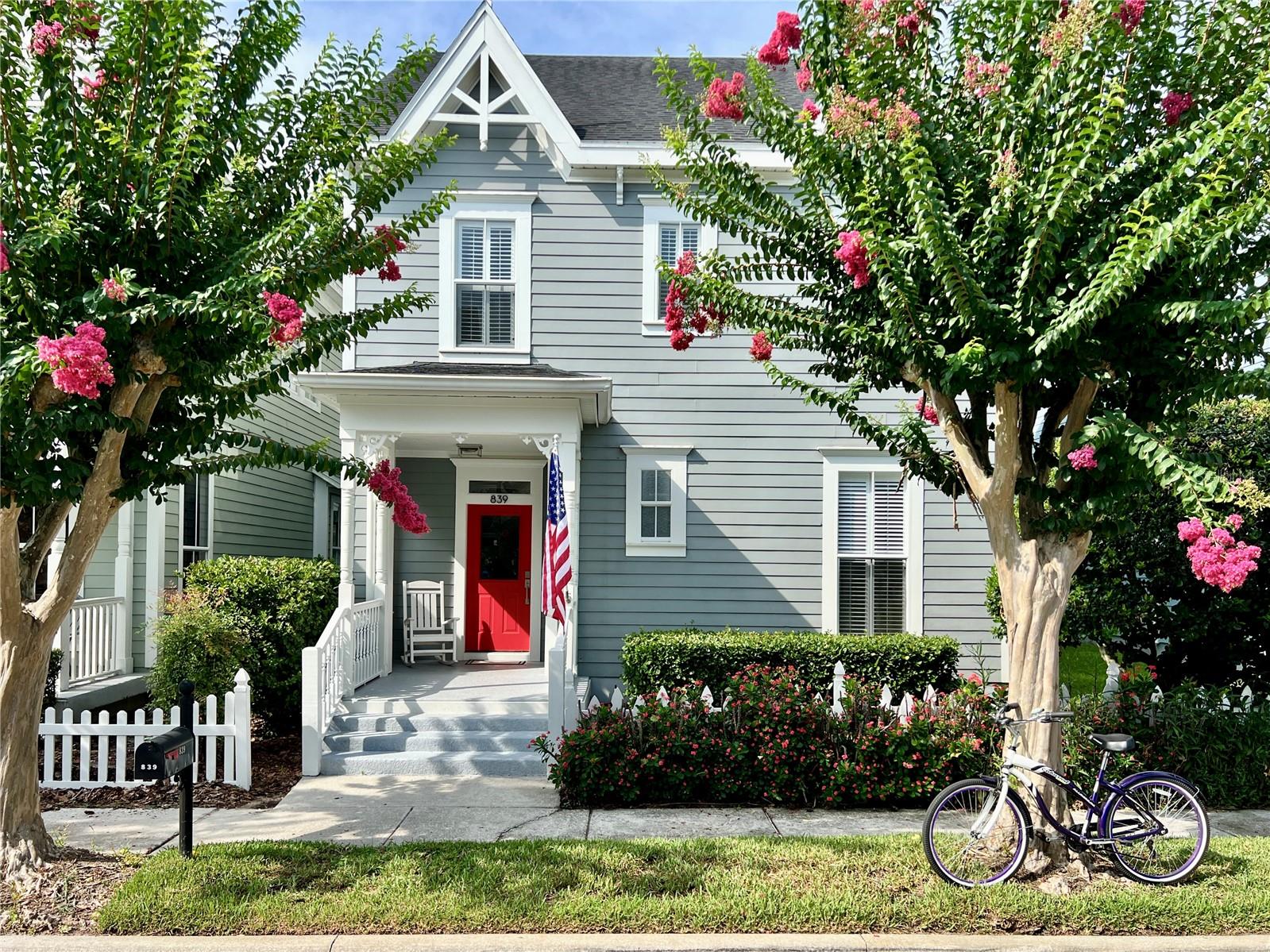 Imagine riding your bike along Celebration's picturesque trails, winding beneath majestic oak trees and over charming wooden boardwalks as you make your way to Downtown Celebration. Stop for your favorite coffee, browse the Saturday Farmers Market, enjoy lunch at one of the inviting restaurants, or simply stroll the lakeside streets that make the town Disney built one of the most beloved communities in Florida.
Now imagine coming home. Welcome to 839 Lake Evalyn Street—one of Celebration's coveted Storybook Homes, beautifully remodeled and thoughtfully expanded to blend timeless charm with modern living. Nestled on a private conservation homesite with no rear neighbors, this enchanting residence offers nearly 2,200 square feet of thoughtfully designed living space, including 5 bedrooms, 3 full bathrooms, a dedicated home office, and a spacious flex room created during the home's renovation. Whether you envision a playroom, media room, fitness studio, or second family room, the flexible layout adapts beautifully to your lifestyle. The first floor features a bedroom and full bath, ideal for guests or multigenerational living, while upstairs the oversized primary suite overlooks gorgeous blooming crepe myrtle trees and includes a custom-designed walk-in closet. Life here extends well beyond the walls of the home. Picture yourself sipping your morning coffee from the welcoming front porch as neighbors wave during their morning walks, bicycles riding through the neighborhood, and the peaceful sounds of nature set the tone for the day. In the evenings, relax in a rocking chair while enjoying the quiet beauty of one of Celebration's most charming streets. The rear alley leads to your attached two-car garage with additional bike storage—because chances are your bicycles will become one of your favorite ways to explore the miles of nearby walking and biking trails. Located just a short stroll from the award-winning Celebration K-8 School and only minutes from Downtown Celebration, this home offers a lifestyle where coffee shops, waterfront dining, boutique shopping, community events, holiday celebrations, and lakeside sunsets become part of your everyday routine. This isn't simply a home—it's a lifestyle. Welcome to 839 Lake Evalyn Street, where storybook charm, modern updates, and the magic of Celebration come together to create a place you'll love coming home to. Don't miss our cinematic video tour and experience this extraordinary home for yourself.