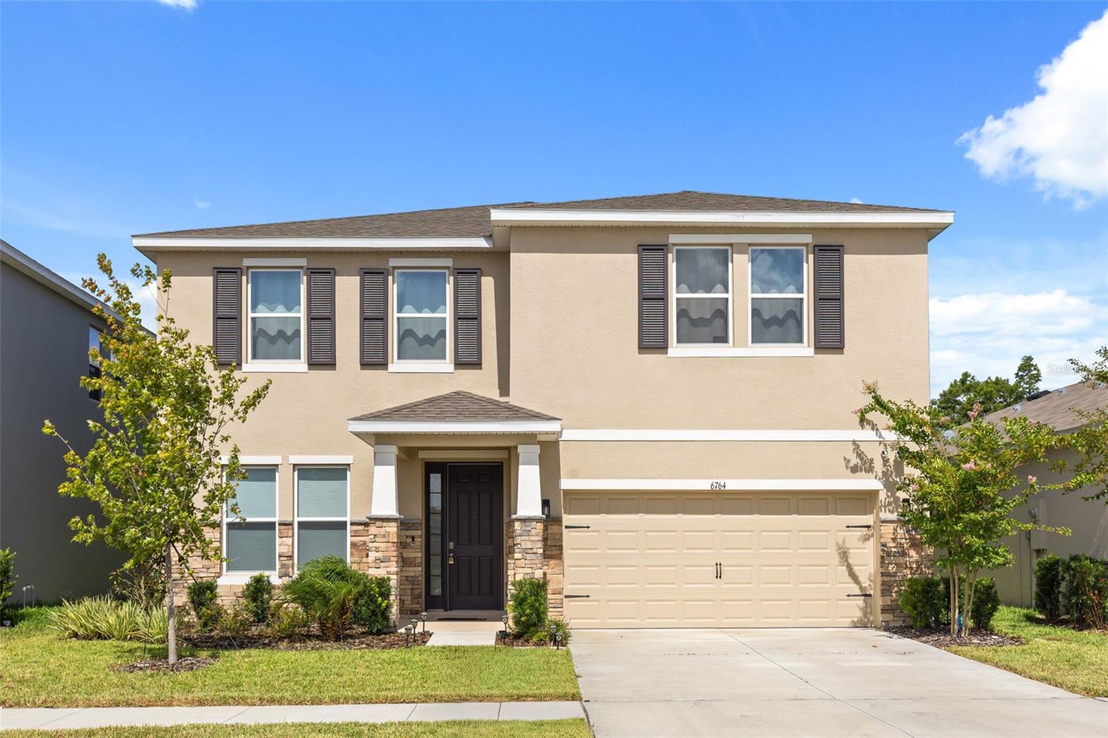 Welcome to this stunning **2025 D.R. Horton Holden model**, offering **4 bedrooms, 3 full bathrooms**, and an incredibly versatile floor plan designed for today's lifestyle. Built with **all-concrete block construction on both the first and second stories** and equipped with **D.R. Horton's Smart Home System**, this home combines quality, efficiency, and modern convenience.

Step inside to discover an open-concept layout where the spacious kitchen, dining, and living areas flow effortlessly together, creating the perfect setting for everyday living and entertaining. The first floor features a private bedroom and full bath, along with a flexible den that can serve as a home office, library, playroom, or guest space, making this home ideal for multi-generational living or visitors.

Upstairs, an expansive loft provides endless possibilities as a second family room, media room, game room, or study area. The thoughtfully designed primary suite offers a true retreat, complete with its own attached flex room that's perfect for a private office, reading nook, nursery, or fitness space. Additional storage nooks throughout both levels ensure you'll have room for everything that matters.

Enjoy peaceful pond views from the covered rear patio, creating the perfect backdrop for your morning coffee or relaxing evenings outdoors.

Residents enjoy access to the community pool and the benefits of living in one of **Land O' Lakes'** fastest-growing areas, known for its newer neighborhoods, scenic surroundings, and excellent value. Conveniently located with easy access to Tampa, Wesley Chapel, shopping, dining, parks, and major commuter routes, this home offers the perfect balance of comfort, flexibility, and location.

If you've been searching for a home with abundant living space, flexible rooms that adapt to your lifestyle, modern construction, and tranquil water views, this exceptional property is ready to welcome you home.
