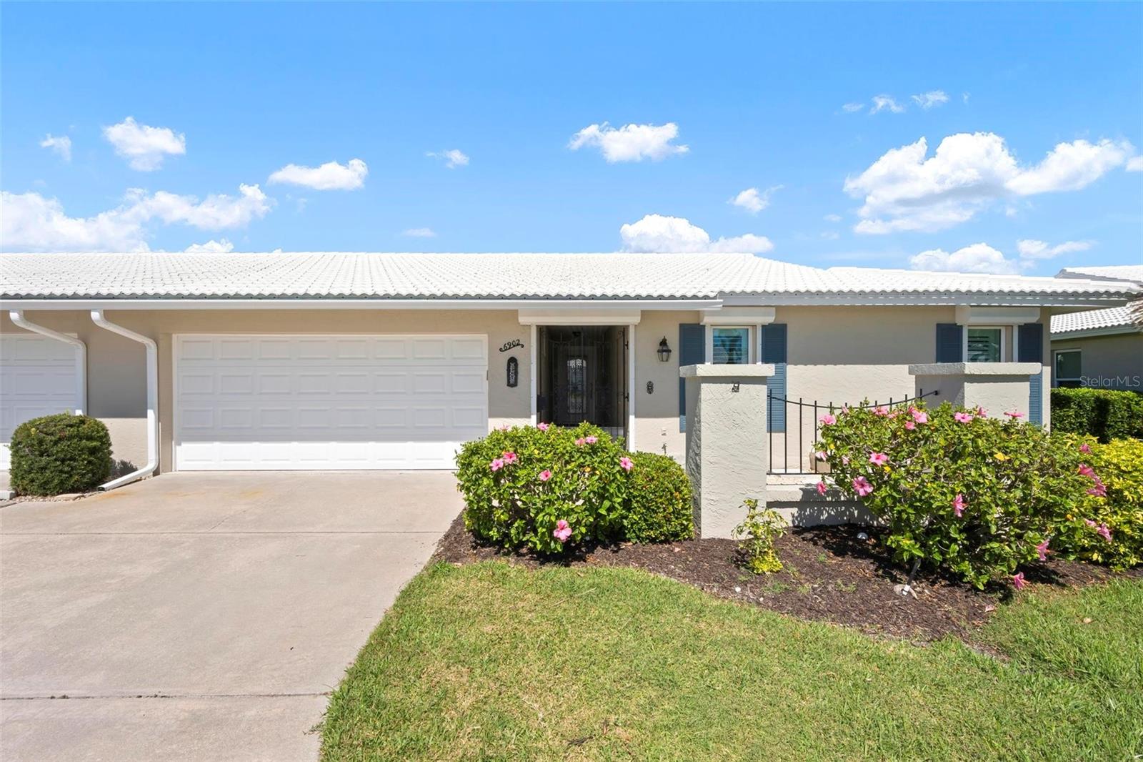 One or more photo(s) has been virtually staged. MOVE IN READY, UPDATED, HURRICANE REINFORCED, FLOOD ZONE X! 
(No Flood Ins Required) It does not get better than this! 
Located on a quiet cul-de-sac, this 55+ community of Village Green is appropriately
named for its uniquely generous GREEN SPACE right outside your back door, encircling
your private community pool &amp; cabana.
This beautifully updated 2BR 2Bath home features a large open spacious floor plan with
sophisticated finishes, recessed lighting, ceiling fans, plantation shutters, and luxury
wood grain vinyl flooring throughout.
The custom-designed kitchen is complete with soft close cabinets featuring roll-out
shelves, deep drawers, granite countertops, tile backsplash, stainless-steel appliances
and a Culligan reverse osmosis system for purified water at the kitchen sink and ice
maker. The master bedroom with ensuite offers a unique walk-in custom spa shower. 
A dedicated laundry room includes a front-load washer and dryer, a utility sink for added
convenience and lots of additional space for a personal office or pantry.  Built for Florida
living, recent upgrades included impact windows and doors supported by additional
rolldown and metal panel shutters providing comprehensive storm protection. The
oversized two-car garage includes shelf storage and attic storage accessible by drop-
down stairs and a 2nd utility sink for convenience.
This section of Village Green boasts the lowest HOA fees of all sections. Quarterly HOA fees
include landscape and irrigation service as well as basic cable/internet, exterior painting,
annual roof cleaning, exterior pest control, pool upkeep, common area taxes, escrow
reserve.  Centrally located in Bradenton, and under 10 minutes from gulf coast beaches
of Anna Maria, shopping and dining, Village Green remains one of the most affordable
and well-maintained communities in the area. Schedule your private tour today to make
this Village Green gem your own!