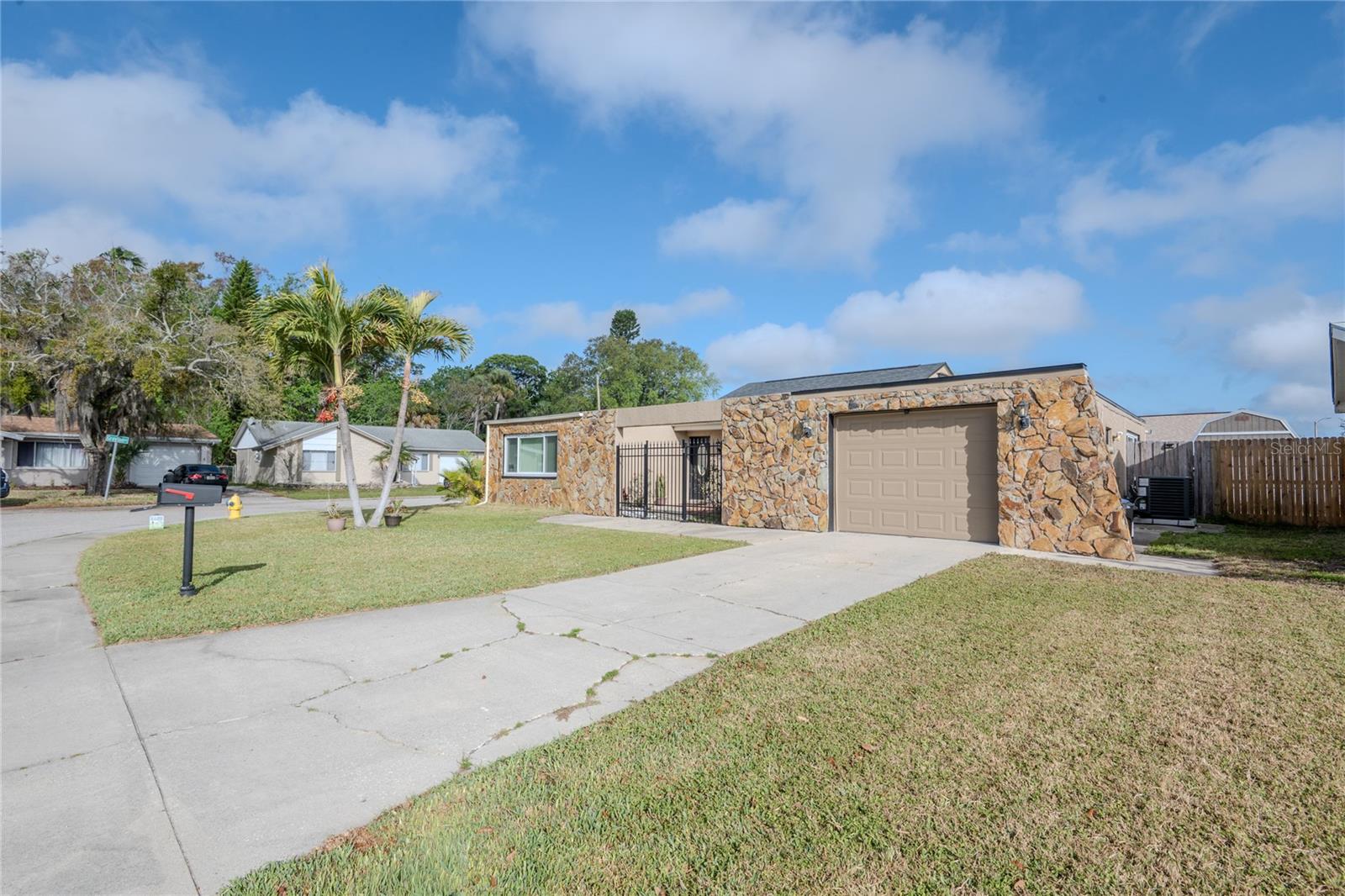 Welcome home to this beautifully maintained 2-bedroom, 2-bathroom single-story residence situated on a desirable corner lot in New Port Richey! From the moment you arrive, you’ll be greeted by a bright and spacious living room filled with natural light and enhanced by stylish tile flooring throughout. The well-appointed kitchen is perfect for both everyday living and entertaining, featuring stainless steel appliances, ample cabinet space, soft-close drawers, granite countertops, and a stunning backsplash that ties it all together. Step outside to the enclosed lanai—an ideal space for hosting guests or simply relaxing year-round. Additional highlights include an energy-efficient EcoSmart water heater, ensuring comfort and convenience. Don’t miss your opportunity to make this charming home yours—schedule your private showing today!
