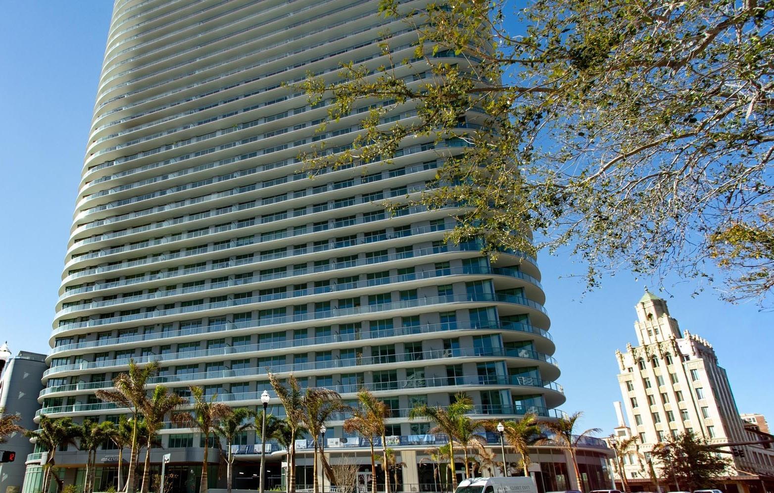 A statement of success—panoramic views and refined living from one of St. Petersburg’s most prestigious towers, in the vibrant heart of downtown. This refined 3-bedroom, 3.5-bath residence at 400 Central features 10’ ceilings and walls of glass that flood the home with natural light. An expansive wrap around terrace spans the full length of the residence, offering seamless indoor-outdoor living and panoramic views from the living area and all 3 bedrooms.
The gourmet kitchen highlights Italian cabinetry with under-cabinet lighting, quartz countertops, and JennAir stainless appliances, including a 36" gas cooktop and refrigerator. The owner’s suite bath features an enclosed glass shower with multiple shower heads, Grohe fixtures, and a Calcutta-pattern backsplash. Prestige Dolomiti matte tile throughout, Whirlpool washer/dryer, built-in medicine cabinets with adjustable lighting and time display, and pre-wiring for electronic shades.
Residents enjoy over 36,000 SF of amenities, including a resort-style heated pool, fitness center, Zen garden, cabanas, theater lounge, private dining room, and a 45th-floor Sky Lounge with 360° views of Tampa Bay and the Gulf. Maintenance-free, lock-and-leave living in the heart of downtown St. Petersburg.