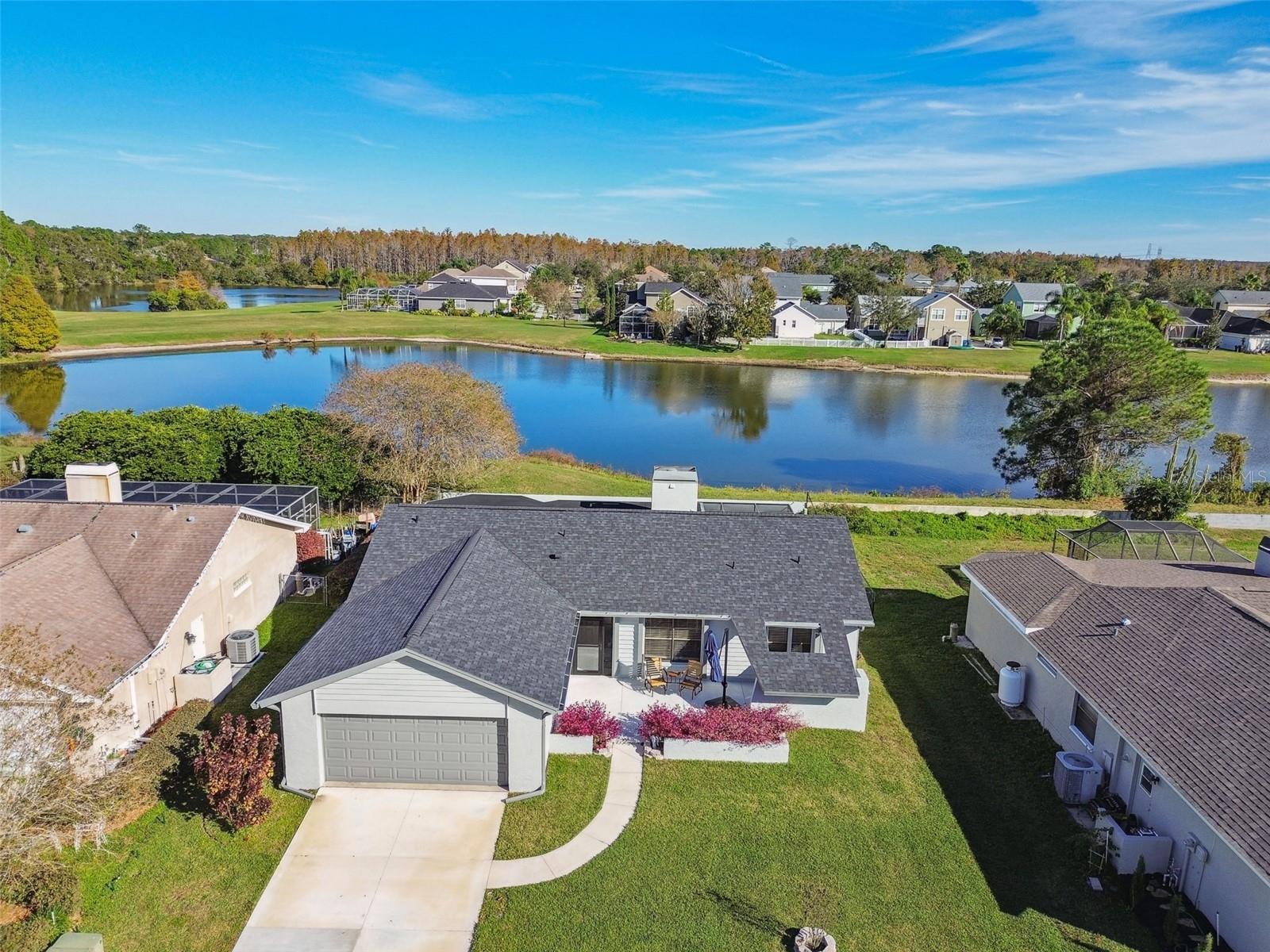 WATERFRONT, FULLY RENOVATED, MOVE-IN READY HOME. 100% financing available through USDA, FHA and conventional loan products! Interest rates as low as in the 6s!
 
Whether you want excellent schools, shopping, dining, being close to the Gulf, close to golf, YMCA, or need a highly rated hospital, this is the perfect location in Fairway Springs. Ample cycling, hiking, skating, walking trails are moments away in one direction or drive to beaches in the other. Easy access to SR 54, Suncoast Expressway, I-75/275, Tampa airport, downtown Tampa, & US Hwy 19. Top A-rated Elementary, Middle and High School. Split/open floor plan with 3 Bedrooms / 2 Bathrooms / 2 Car Garage. Low HOA only $368.00 annual/year, NO CDD!

Spacious living room with cathedral ceilings, tons of natural light, a view of the water and wood burning fireplace. Completely renovated kitchen has a breakfast bar and separate large eat-in kitchen area overlooking the private backyard and gorgeous pond. "HUGE" covered (and uncovered area) screened lanai. Just imagine entertaining family and friends on your backyard oasis. Primary suite has a large walk-in closet, en-suite bathroom. 3rd bedroom has lockable barn doors, built-in closets, could be home office or flex space. Inside utility/laundry room has a window with lots of natural light, and includes washer & dryer. Additional storage closets/pantry in hallway.

New Roof (Oct 2022) ~ New Exterior Paint (Nov 2023) ~ HVAC, new AC registers and new ductwork (2020) ~  New Lanai tile (2023) ~ New tiled privacy wall in screened area (2023) ~ New tiled front porch entry (2023) ~ New (added) front concrete patio, sidewalk and driveway (2023) ~ New wood-look tile floors throughout the entire home (2021) ~ New storm door at front entry (2023) ~ New gutters (2020) ~ New black chain link fence (2020) ~ New baseboards & door trim (2021) ~ New ceilings in rear lanai and front entry were replaced with tongue and groove wood - sealed (2023) ~ . New interior and exterior light fixtures and ceiling fans throughout (2020) ~ Kitchen remodeled with all new cabinets, quartz countertops, backsplash, new stainless steel appliances and pantry cabinets (2020) ~ All popcorn ceiling texture removed and replaced with knockdown texture and painted (2020) ~  New blinds and curtains throughout home (2020/23) ~ Fireplace brick, hearth and mantle replaced with modern tile and poured decorative concrete and beautiful live-edge mantle (2022) ~  New live-edge decorative shelf installed in kitchen (2020) ~ New toilets in both bathrooms with comfort height oval toilets (2021) ~ New extra large laundry sink installed in utility room (2021) ~ New shelving throughout home in closets and utility room were wire shelving and were replaced with solid wood shelving (2021) ~ Lanai screened porch was painted and rescreened (2020) ~  Interior walls painted (2020) ~  New shelving installed in garage (2021) ~ New interior closet and utility room doors replaced (2021) ~ New interior door hardware replaced throughout (2021) ~ Kitchen sink and plumbing fixtures (2020) ~ Electrical plates replaced throughout (2020).