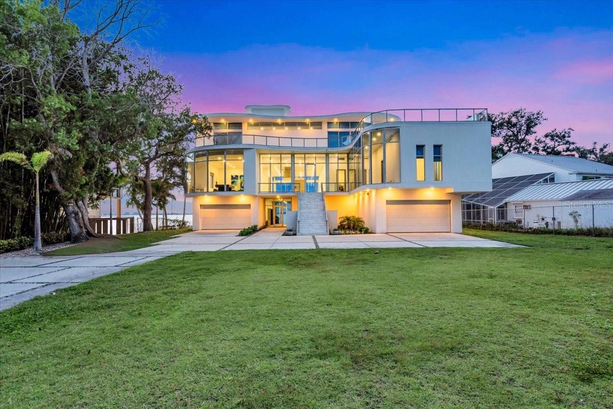 An Architectural Masterpiece on Sarasota Bay. Commanding one of Sarasota’s most spectacular bayfront settings, this gated estate blends cutting-edge engineering with timeless coastal living. Built on 55 deep concrete piles extending 30 feet underground, the home is constructed entirely of cast-in-place concrete and masonry, including every slab and the roof, creating a true hurricane fortress designed to endure generations. A massive 8-car garage sits beneath this elevated residence on an oversized, fenced lot, offering both privacy and security. Inside, the open-concept layout was intentionally designed with no interior bearing walls, supported only by a few discreet columns per floor—allowing future owners to reimagine the floor plan freely to suit any lifestyle. Outdoors, the property feels like a private resort. The waterfront pool area features sunken seating and a swim-up bar, perfect for entertaining or soaking in Sarasota’s sunsets over the bay. An elevator serves all levels, including the roof, where there’s potential for an extraordinary rooftop terrace with panoramic views of Sarasota Bay and the skyline. Documents are currently being finalized for a dock permit, which will enhance the property’s existing direct Sarasota Bay access and allow for private boat docking in the future. 4035 Bay Shore Road isn’t just built, it’s engineered to impress. A home where modern strength meets pure waterfront serenity.
