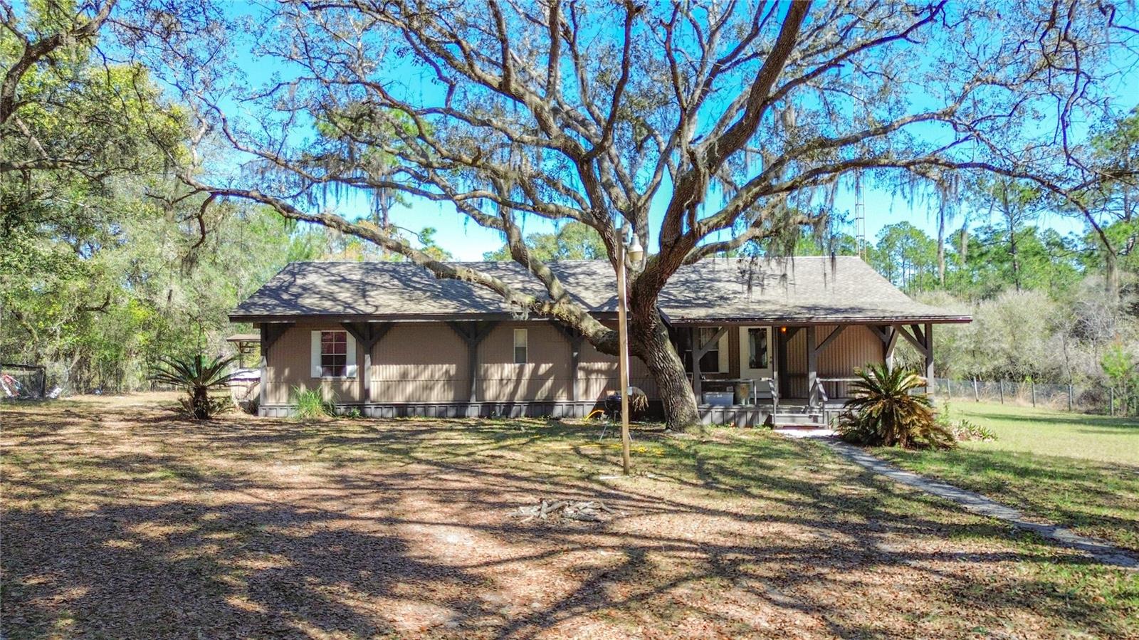 Peaceful country living on 8.29 fully fenced acres! Unique property featuring a mobile home attached to a concrete block home, offering a spacious 4-bedroom, 2-bath layout with 2,365 living sq. ft. Recent updates include a new HVAC (2025) and roof (2022). Large kitchen with plenty of cabinet space, open living and dining area, and a covered back porch perfect for relaxing. Bonus room ideal for an office, gym, or additional living space... The property also includes an 18’ x 30’ workshop with power and water—great for hobbies, storage, or equipment. Conveniently located near outdoor recreation including the Ocala National Forest, Silver Springs State Park, and the Ocklawaha River. Plenty of space for animals, toys, and enjoying the quiet country lifestyle.