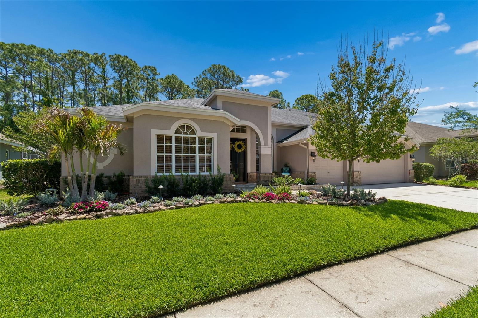 Behind the guarded, tree-lined entrance of The Greens, Westchase’s most coveted gated enclave, this exceptional residence offers a lifestyle defined by elegance, serenity, and refined design. Perfectly positioned on the 6th fairway of the Westchase Golf Course, the home welcomes you with soaring ceilings, crown molding, and sweeping views of the pool and golf course. The formal living and dining rooms feature architectural niches, updated lighting, and a tray ceiling, creating an elegant setting for entertaining. 
The chef’s kitchen, remodeled in 2021, showcases upgraded cabinetry with pull-out drawers, granite countertops, a glass subway tile backsplash, a massive center island, a built-in pantry, and stainless-steel appliances, including a Wi-Fi–enabled smart double oven with built-in air fryer and a GE Monogram 6-burner gas stove with 36-inch hood. A farmhouse sink with a commercial-grade faucet and a wineglass cleaner add distinctive luxury. Adjacent is a 800 bottle climate-controlled wine room with cedar shelving and an updated cooling system (2024). The breakfast nook overlooks the backyard oasis, the 36-inch tile laid on a diagonal flows seamlessly into the light-filled family room with a picture window and new pocket sliders opening to the lanai. 
The outdoor living space features a sprawling brick-paver, screen-enclosed lanai, an oversized Pebble Tec saltwater pool, spill-over spa, faux-stone waterfall, and lush landscaping for added privacy. Inside, glass French doors lead to a dedicated home office. The primary suite has plantation shutters, pool access, dual walk-in closets, and a spa-inspired ensuite bath fully renovated in 2023. Two additional bedrooms and two full baths—one serving as a pool bath—are located on the main level. The second floor includes a private guest retreat with a bedroom, full bath, bonus room, and flexible space ideal for media or hobbies. 
A main floor bedroom has been transformed into a luxury laundry suite with near new appliances and built-in shelving. Upstairs flooring was updated in 2021 with stylish, low-maintenance LVP. The 2 1/2-car garage features epoxy floors, insulated doors, and a dedicated golf-cart space. Additional upgrades include new interior paint (2022), sealed brick pavers (2021), pool pump (2020), roof (2018), south side windows have been replaced to be hurricane resistant, main floor tiles are 36’ set in a diagonal pattern throughout the first level (2023), LED recessed lighting, a Halo whole-home water system, Navien tankless water heater, refreshed front landscaping, exterior lighting, new A/C system for the 2nd floor, and raised garden beds with an automated watering system. The refrigerator (2026) and microwave (2025) complete the home’s turnkey appeal. 
Located in one of Tampa Bay’s premier master-planned communities, residents enjoy an 18-hole golf course, clubhouse, two swim and tennis centers, parks, playgrounds, and vibrant social events. Zoned for top-rated Westchase schools and close to shopping, dining, and major conveniences, this home offers the pinnacle of luxury living.