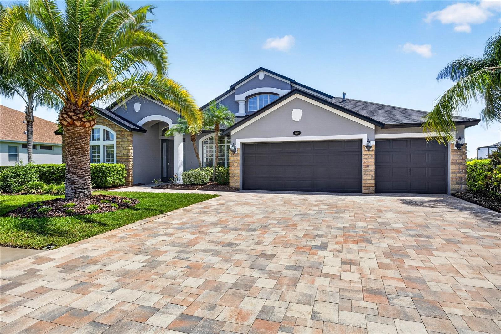 Welcome To 16339 Ivy Lake Drive, a Rare Opportunity To Own the Highly Sought-After Hampton Model in the Gated Community of Ivy Lake Estates. Perfectly Positioned on a RARE Premium Waterfront Homesite Along Beautiful Ivy Lake, This Exceptional 5 Bedroom, 3 Bathroom Residence Offers Breathtaking Water Views, an Impressive Floor Plan, & the Ideal Combination of Luxury, Comfort, & Functionality. From the Moment You Arrive, You'll Appreciate the Extensive Exterior Enhancements That Elevate This Home's Curb Appeal & Outdoor Living Experience. Beautiful Brick Pavers Adorn the Front Driveway, Creating a Stunning First Impression, While the Backyard Showcases a Modern Extended Lanai Cage, Expanded Covered Seating Area, & Complementary Brick Pavers Surrounding the Saltwater Pool, Creating the Ultimate Waterfront Retreat. A Dedicated Office Located at the Front of the Home Provides the Perfect Work-From-Home Environment, While Also Offering Flexibility as a Den, Library, or Additional Living Space. The Formal Dining Room Creates an Elegant Setting For Family Gatherings & Special Occasions. At the Heart of the Home Is the Spacious Open-Concept Kitchen & Dinette Area, Featuring Abundant Cabinetry, Generous Counter Space, Ample Storage, & a Seamless Flow Into the Main Living Areas, Making Everyday Living & Entertaining Effortless. The Primary Suite Is a True Retreat, Showcasing Stunning Lake Views, a Beautiful En-Suite Bathroom, & a Custom Walk-In Closet. Four Additional Bedrooms & Two Full Bathrooms Complete the Main Living Area, Providing Plenty of Space For Family & Guests. Upstairs, the Oversized Bonus Room Offers Incredible Flexibility While Continuing To Capture the Spectacular Lake Views. Whether Used as a Home Theater, Fitness Room, Game Room, Guest Suite, or Additional Office Space, the Possibilities Are Endless. Step Outside To Your Private Backyard Oasis Featuring a Beautifully Maintained Saltwater Pool Overlooking Ivy Lake. This Exceptional Outdoor Space Provides the Perfect Setting For Relaxation, Entertaining, or Simply Enjoying the Peaceful Waterfront Surroundings. Additional Major Updates Provide Peace of Mind, Including a New Roof (2021), New Main AC System (2022), New Water Heater (2021), & New Pool Pump (2026), Allowing the Next Owner To Enjoy Years of Worry-Free Living. Residents of Ivy Lake Estates Enjoy Access To Beautifully Maintained Grounds, Parks, Playgrounds, Basketball Courts, & Scenic Walking Paths. Conveniently Located Near the Suncoast Parkway, This Home Offers Easy Access To Top-Rated Schools, Shopping, Dining, Tampa International Airport, Championship Golf Courses, & Florida's World-Famous Gulf Coast Beaches. With Low HOA Fees, No CDD Fees, an Outstanding Waterfront Location, Extensive Recent Improvements, & One of the Community's Most Popular Floor Plans, This Home Presents a Truly Exceptional Opportunity To Own in One of Odessa's Premier Neighborhoods.