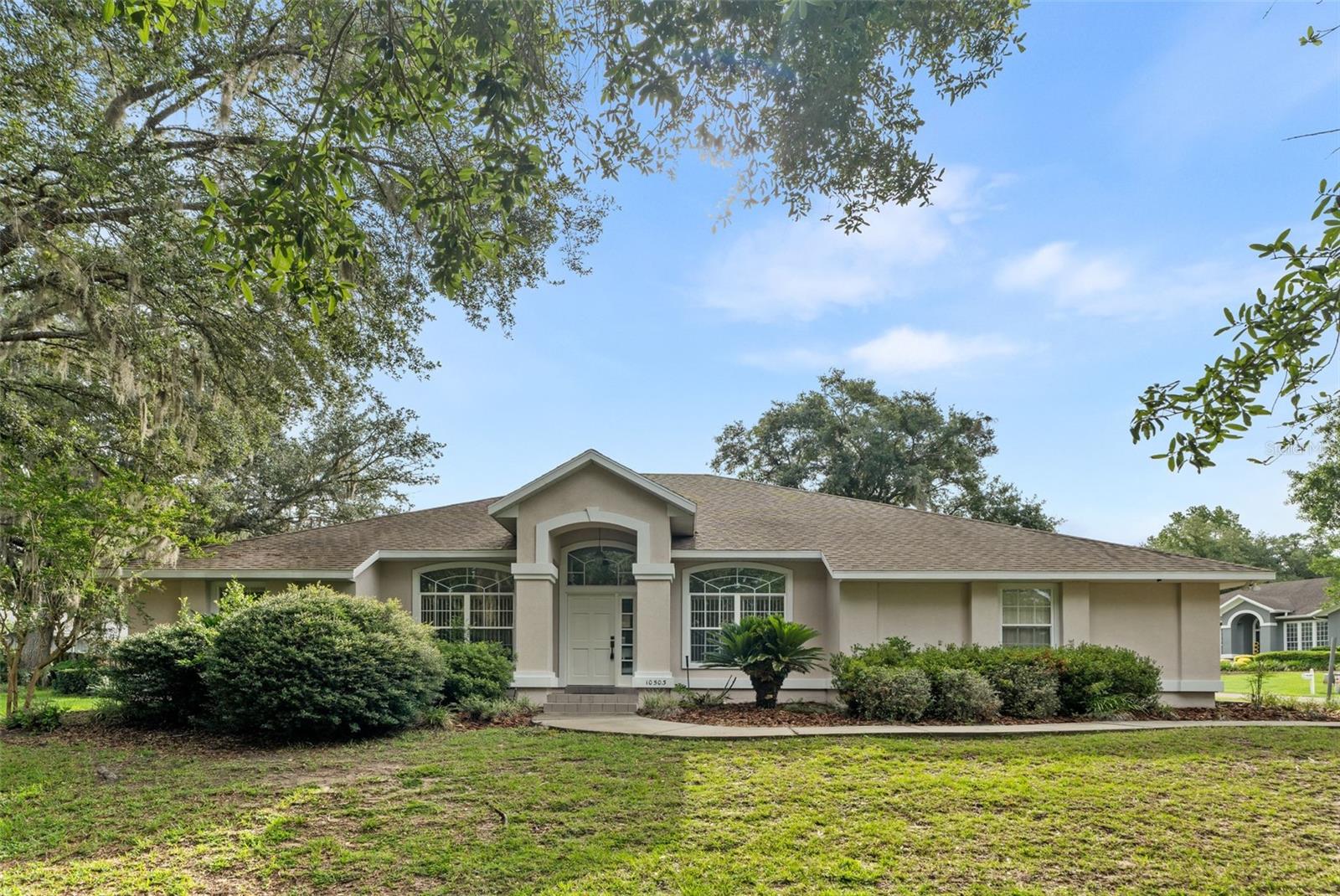 Located in the gated golf course community of Turkey Creek, this spacious 4-bedroom, 3-bath home offers over 2,200 heated square feet and a thoughtfully designed layout filled with natural light. Multiple living and dining areas provide flexibility for everyday living and entertaining, including formal living and dining rooms and a spacious great room with a cozy fireplace and built-in shelving. The kitchen offers abundant cabinet space, a breakfast bar, and opens seamlessly to the main gathering spaces. A bright, covered, and enclosed sunroom with large windows with screens that can be opened or closed provides additional space to relax, enjoy your morning coffee, or take in views of the backyard. The primary suite features dual vanities, a garden tub, and a separate shower. A side-entry two-car garage and mature landscaping add to the home's curb appeal. Residents enjoy exceptional community amenities, including the Turkey Creek golf course, clubhouse and restaurant, community pool, tennis and pickleball courts, playground, and scenic walking paths, all just minutes from Gainesville and I-75.