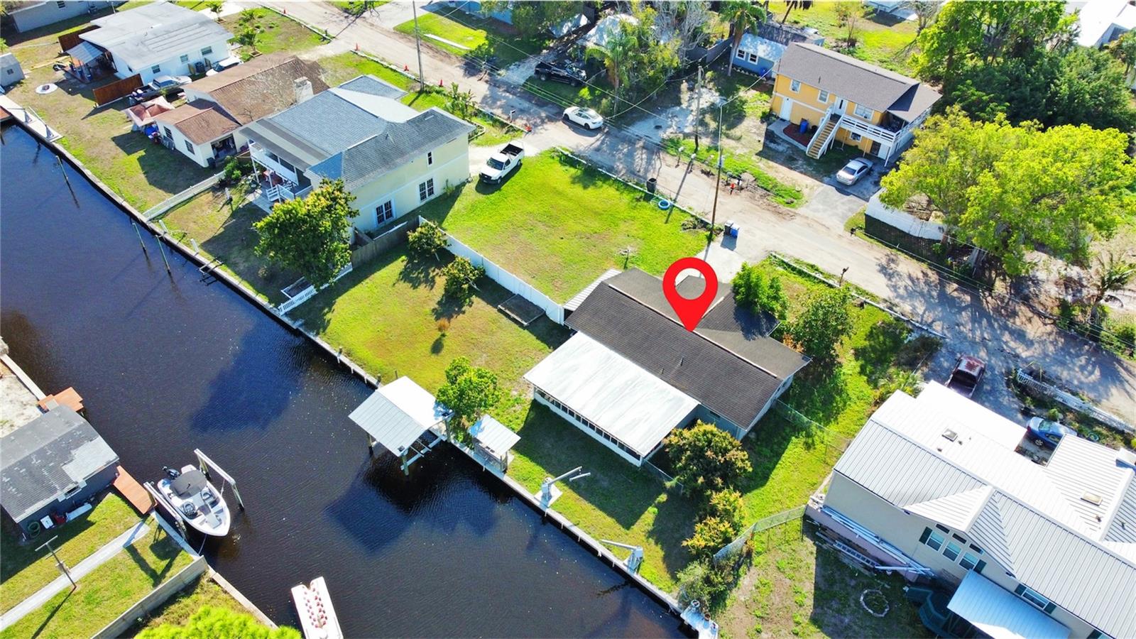One or more photo(s) has been virtually staged. Beautifully renovated 3-bedroom, 2-bath waterfront home on a rare double lot with direct canal frontage. This updated property offers the ultimate Florida lifestyle, complete with two private boat lifts, a fish prep station, and peaceful water views right from your backyard. The outdoor space is truly special, with multiple mature mango trees creating a private, tropical setting where you can enjoy fresh fruit and serene surroundings year-round. Combining comfort, functionality, and exceptional outdoor living, this home is a rare opportunity for boaters, anglers, and anyone looking to enjoy the best of waterfront living.