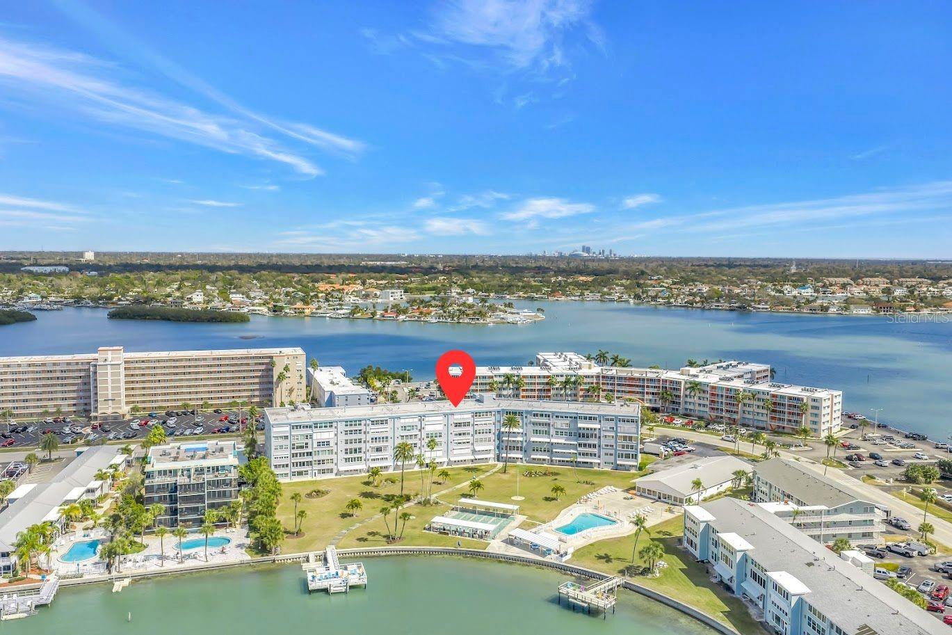 Wake up to shimmering water views every day in this beautifully updated 1-bedroom condo in the desirable Shore Towers 55+ building— perfectly positioned on the shores of Boca Ciega Bay. Bright, open, and generously sized, this residence offers peaceful living. The kitchen has been tastefully refreshed with crisp white shaker cabinetry, granite countertops, a full suite of stainless steel appliances, and a warm bamboo Roman shade that brings in just the right coastal texture. The open living area flows effortlessly, showcasing sweeping views of the bay through large windows in your Florida room — a daily reminder of why you chose waterfront living. Featuring a large primary bedroom with a walk-in closet, and a bathroom equally impressive, featuring a marble-look granite vanity, white shaker cabinetry, brushed nickel fixtures, and coastal-inspired accents that carry the breezy theme throughout. Life at Shore Towers goes well beyond your front door. The community amenities are exceptional — dive into the resort-style pool, challenge a neighbor to shuffleboard, or fire up the grills in the al fresco dining area. The private dock is a dream for fishing, kayaking, and paddleboarding, and the sunsets from the waterfront are simply unmatched. The fully equipped clubhouse features a social room with pool tables, a fitness center, and a full kitchen — everything you need for an active, connected lifestyle. Ideally located just 5 minutes from the world-renowned St. Pete Beach and 15 minutes from the vibrant energy of downtown St. Petersburg, this is Tampa Bay living at its finest — relaxed, beautiful, and right on the water.