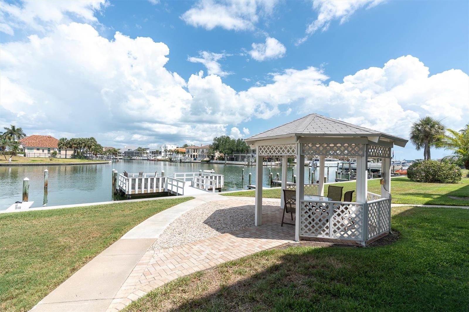 Island living awaits you in this updated and furnished 2 bedroom/ 2 bath condo in Tierra Verde! The waterfront community of Tierra I provides a large beautiful dock which is a perfect location to watch manatees and dolphins swim by, throw out a fishing line or just relax & sip on an evening cocktail. It also features tennis &  pickleball courts, a heated waterfront pool, fitness & social room, a hobby room for those that like to tinker, covered bicycle and kayak  storage, your own designated parking space and extra storage closet. The complex has 7 boats slips that are available on a first come/ first serve basis for $85/month.  The unit has everything you need to be comfortable- updated kitchen and baths, a split bedroom plan, 2024 HVAC and NEW gemstone balcony flooring. The primary bedroom is spacious and offers a ensuite bathroom and large walk in closet with sliding doors to the large 11'x 16' balcony! This is perfect for full time living or a 2nd home! Centrally located, you are 5 minutes to the beautiful beaches of St Pete Beach, Pass A Grille or Ft Desoto, 12 minutes to the happening down town and 30 minutes to Tampa. Come take a look at this one!