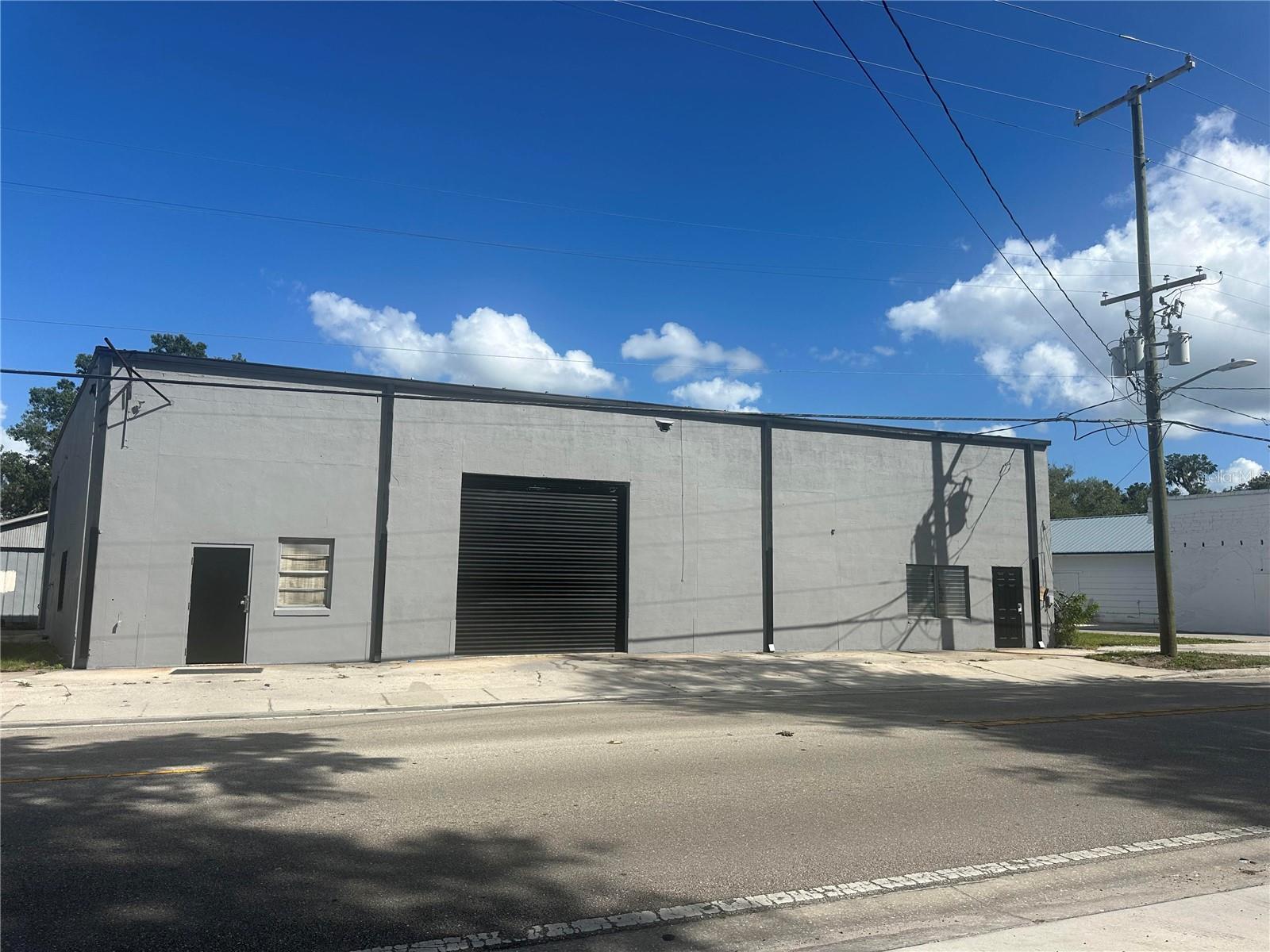 A business location less than the cost of a house! Zoned for Automotive/Repair Garage, Warehouse, Inventory storage, packaging business, antique car storage and/or restoration, Speed shop for race cars. Business was operating for years as an Automotive Machine Shop/ building race cars. Over the years it has been divided into 2 businesses, with two addresses and electric meters. Inside wall has been removed and it is now completely open with massive open space. 4 roll up Outside doors include a 10' 12' and (2) 14' doors all in operating condition. 2 Ton hoist runs along the center beam with another hoist on a 10' beam spins at 360-degree (could be left or removed) Includes a 9000 lb. lift. Also, slab poured outside North end for previous outside lift (lift has been removed) Building has 3 phase wiring, LED lighting, air compressor (plumbed throughout the building) Upstairs office has a 3/4 bath and downstairs two offices have a bathroom. The property was re-roofed in 2004 with a pitched metal roof. Under layer of ceiling was not removed because it provides more insulation. A buyer could easily cover it or add a second ceiling if being used for a showroom floor or a business that interior appearance is needed.  This building fronts on a main City Road (Florida Avenue) and is easily accessible for truck/customer service deliveries.  Great customer parking on the North side with room for employee/customer parking on the South side if needed. Total parking could be 18-25 parking spaces. A city alley runs along the back side of the building.  This building is a solid, concrete block building that could have multiple uses. Hardee County is a rural, interior county, but within one to two hours from airports in Orlando, Tamp/St Pete, Sarasota, Ft Myers. Call for more information on this listing.