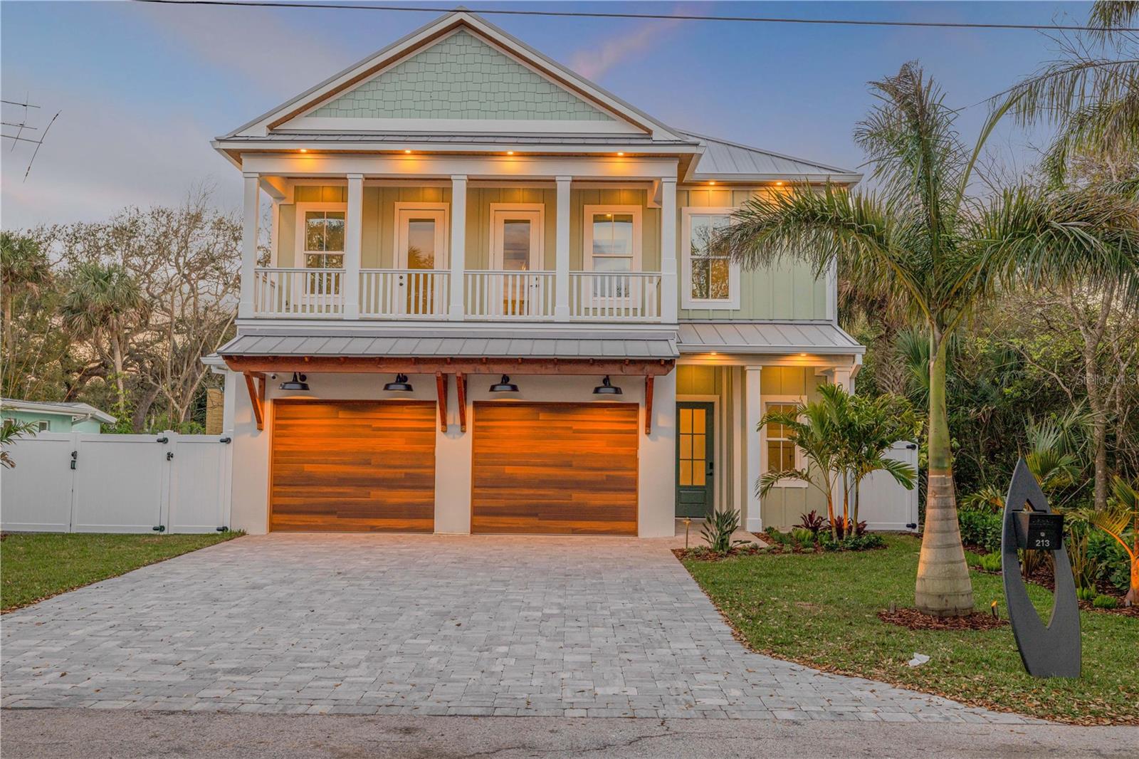 Welcome to a breathtaking year 2025 built beachside coastal masterpiece. It is located deep in the heart of New Smyrna Beach’s historic district. This two-story architectural gem harmoniously blends modern luxury with coastal charm, offering an exquisite living experience.
Spanning five bedrooms, three bathrooms, and a versatile office/bonus room, this stunning home serves as a true sanctuary of sophistication. The open-concept design is adorned with wide-plank white oak, marble, and porcelain tile flooring, complemented by a custom oak staircase and striking quartzite countertops featuring a four-inch thickened edge. The chef’s kitchen is a culinary dream, equipped with top-of-the-line Thermador appliances, including a 42” range, a three-tower fridge/freezer system, wine cooler, under-counter microwave, and a white quartzite waterfall center island.
The luxurious primary suite is a spa-inspired retreat that features a double vanity, deep soaking tub, steam shower, and high-end finishes, creating the perfect escape. High vaulted beamed ceilings enhance the spacious ambiance, while premium impact-rated windows and doors flood the home with natural light. A cozy fireplace adds warmth and charm to the interior. Designed for modern convenience, this fully automated home includes a whole-home generator, a custom-made state-of-the-art audio-visual package, and smart lighting that allows you to customize your environment at the touch of a button.
Step outside to your personal paradise. The designer pool, featuring a sleek black finish, an 8-person spa with a cocktail bench, integrated amber-lit lighting, and a self-cleaning system, is framed by expansive decking for ultimate relaxation and entertainment. The gourmet outdoor kitchen is perfect for alfresco dining, equipped with premium appliances to elevate your outdoor culinary experiences. Enjoy a spacious covered balcony and dual front and back porches that enhance the coastal Florida lifestyle. A custom-made surfboard mailbox adds a signature touch to the property. The epoxy-finished garage offers a sleek, durable space for vehicles and storage.
Located just two blocks to Flagler Avenue, you’re steps away from charming boutiques, award-winning restaurants, and the pristine sandy beaches of New Smyrna Beach. Whether you seek a peaceful retreat or an entertainer’s haven, this home epitomizes elite beachside living. Indulge in perfection—schedule your private tour today and experience the pinnacle of coastal luxury living.