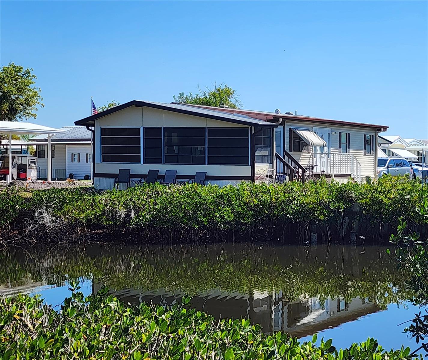 ENJOY THE WATER VIEW FROM THIS TWO BEDROOM 1 1/2 BATH MOBILE HOME IN SUGAR CREEK COUNTRY CLUB--AN ACTIVE 55+ COMMUNITY IN BRADENTON, FLORIDA. This creekside property features an open concept main living area, a rear enclosed lanai that looks out at the water, bedrooms with en suite bathrooms; inside laundry, and room to park two vehicles. Sold turnkey. Central A/C. The community features two swimming pools, heated spa, tennis & pickleball, shuffleboard, fitness room, club house, workshop, and an active social calendar during the winter months. LOW HOA FEES of $600 quarterly which include water, trash, sewer, basic cable, internet, and grass mowing. Enjoy this community's proximity to the Braden River and River Links Golf Course. Sorry this is not a dog lot.