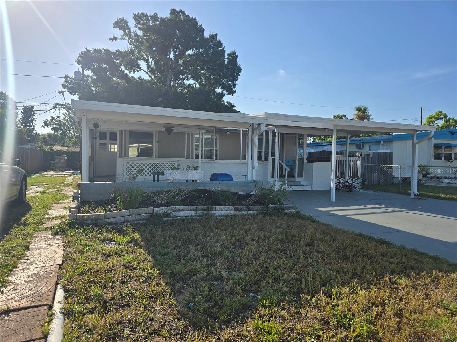 INCOME-PRODUCING INVESTMENT OPPORTUNITY! Start earning rental income from day one with this turnkey investment featuring a tenant already in place. This well-maintained 3-bedroom, 2-bath doublewide manufactured home sits on its own lot with NO HOA and NO age restrictions and is located in a NON-FLOOD ZONE, offering added peace of mind and the potential for lower insurance costs.  Inside, you'll find a spacious open floor plan with generous living and dining areas, a functional kitchen with ample cabinetry, and multiple bonus spaces that provide flexibility and added appeal for tenants. Recent updates include:  Newer HVAC system, Upgraded 150-amp electrical panel, Enhanced electrical grounding and Both bathroom shower units replaced.  The outdoor space is equally impressive, featuring a covered carport, workshop, utility room, storage sheds, a deck, and a fenced yard—offering plenty of room for storage, hobbies, and everyday convenience plus parking for your RV or Boat.  No Deed Restrictions.  Ideally located near shopping, dining, medical facilities, parks, and just minutes from the beautiful Gulf Coast beaches, this property offers tenants the perfect blend of convenience and the Florida lifestyle. Spend the day on the sugar-sand beaches, enjoy fresh waterfront dining, or take in spectacular sunsets—all just a short drive away.  Whether you're looking to expand your investment portfolio or purchase a reliable, income-producing property, this tenant-occupied home is ready to deliver immediate cash flow.  Property is being sold AS-IS for the seller's convenience.
