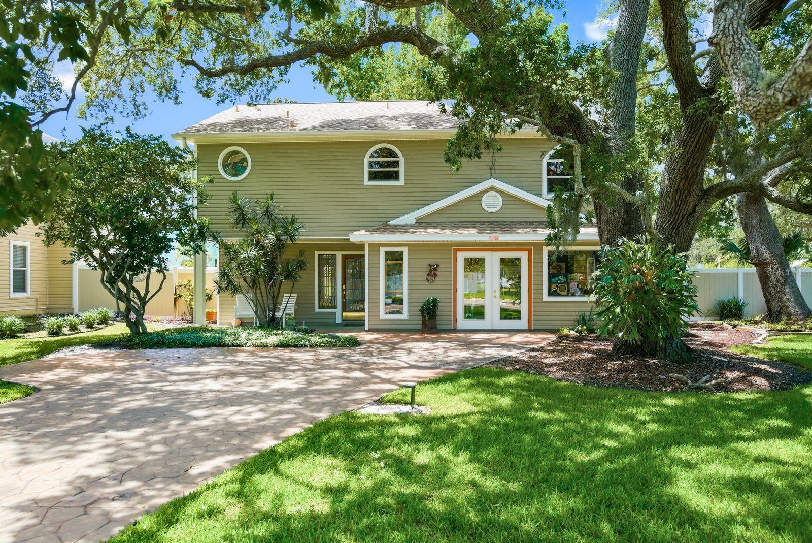 Virtually Staged. Rare opportunity to own a truly one-of-a-kind, character-filled home in the heart of Dunedin. Situated on a meticulously maintained corner lot, located outside of designated flood zones, and just half a mile from both Downtown Dunedin and the Pinellas Trail, this charming two-story residence, built in 2002, offers 2,016 square feet of thoughtfully designed living space with 3 bedrooms, 2 bathrooms, plus a dedicated office. The third bedroom is currently being utilized as a creative studio/workshop, offering flexibility to suit a variety of lifestyles.

From the moment you arrive, you'll be captivated by the mature trees and lush landscaping that frame this exceptional property. Inside, timeless craftsmanship and artistic detail are woven throughout, including custom stained-glass windows, soaring ceilings with skylights, handcrafted tile work, historic art installations, and stunning entrance doors sourced from the early 1930s. Every space tells a story, creating a home that feels both warm and inspiring.

Designed to embrace Florida's coveted indoor-outdoor lifestyle, the home features multiple huricane rated sliding glass doors that lead to an expansive 300-square-foot Trex patio deck perfect for entertaining, relaxing, or enjoying the coastal breeze.

Major updates provide peace of mind, including a 2022 roof, central HVAC system with ducted heating and cooling installed in 2016, and a 2026 water heater equipped with a timer for added efficiency.

Location is everything, and this home delivers. Enjoy easy access to award-winning restaurants, breweries, boutiques, festivals, waterfront parks, and all the charm that makes Dunedin one of Florida's most beloved coastal communities. World-renowned Honeymoon Island State Park is just minutes away, offering pristine beaches, nature trails, and breathtaking Gulf Coast sunsets.

Combining historic charm, artistic character, modern outdoor living, thoughtful updates, and an unbeatable location, 755 San Christopher Drive presents a rare opportunity to own a piece of Dunedin's unique spirit.