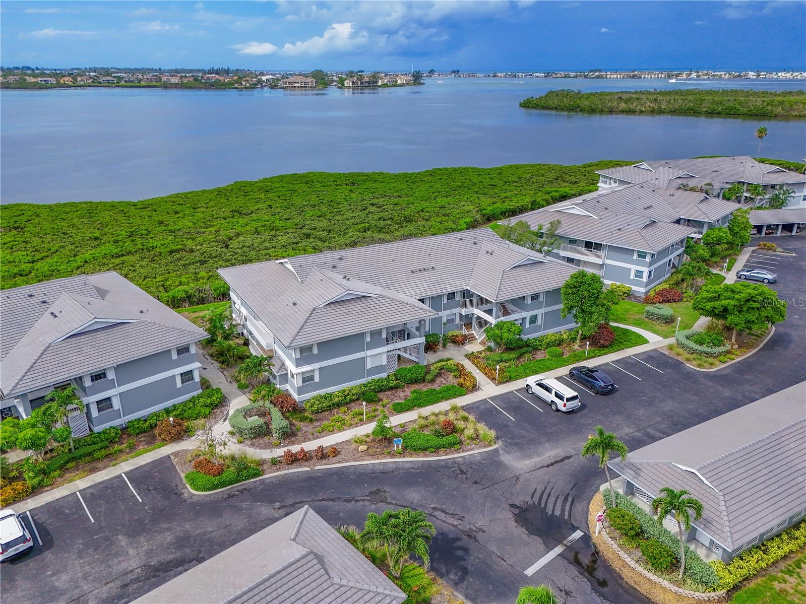 Price Reduction!!  Motivated Seller!!  Welcome to this stunning 3BR/2BA waterfront condo in the coveted, gated community of Perico Bay Club—just minutes from Holmes Beach and Anna Maria Island! This recently updated unit offers breathtaking panoramas of Palma Sola Bay and the Intercoastal Waterway. It's a must see, the pictures don't do it justice! Over $100K in high-end renovations were completed in 2021–2022, including a completely redesigned chef’s kitchen with quartz countertops, soft-close wood cabinetry, stainless steel appliances, glass tile backsplash, breakfast bar, and updated lighting. Walls were removed to create a bright, open-concept layout with seamless flow throughout the main living spaces. Stylish wood-look tile flooring, updated baseboards, and fresh paint elevate the interior. The primary suite features high ceilings, water views, sliding doors to the lanai, and a luxurious, remodeled ensuite bath with a custom shower nook. The guest bathroom has also been beautifully updated. Additional upgrades 2021: new AC unit , hurricane shutters, rescreened lanai, private 1-car garage, and plenty of in-unit storage. This home is steps from one of the community pools. Community amenities include 24/7 security, a clubhouse, two heated pools, fitness center, tennis and pickleball courts, library, kayak launch, walking paths, and more. Recent community improvements include a new roof, freshly painted exterior, and repaved parking areas. This is your chance to own a coastal retreat in one of the area's most sought-after communities. Don't miss it!