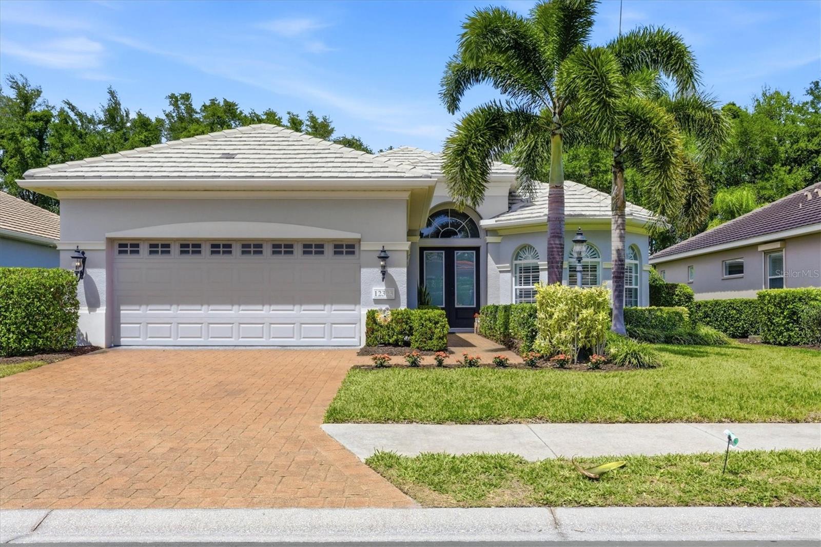 Welcome to 12323 Thornhill Court, a beautifully remodeled Neal Home in the highly desirable Lakewood Ranch Country Club, offering 2,500 square feet of refined living space where timeless design meets modern luxury. Nestled on a private homesite with fantastic curb appeal, this residence delivers both elegance and effortless maintenance-free living. Step inside to discover a thoughtfully updated interior featuring gorgeous engineered oak flooring, plantation shutters, and designer lighting throughout. The heart of the home is the completely renovated kitchen, showcasing new custom cabinetry, stylish lighting, a charming farm sink, wine fridge, and high-end finishes—perfect for both everyday living and entertaining. This spacious floor plan includes three bedrooms plus a generously sized office, ideal for working from home or hosting guests. The air-conditioned garage adds comfort and versatility, offering the perfect space for storage, hobbies, or keeping your vehicle cool year-round. Outdoor living is equally impressive with a well-appointed outdoor kitchen featuring a gas grill, creating an inviting space to relax and enjoy Florida’s beautiful weather. All of this is just a short golf cart ride from the club amenities, making it easy to enjoy the premier country club lifestyle. Experience privacy, style, and convenience in this exceptional home—where every detail has been carefully curated for comfort and elegance.