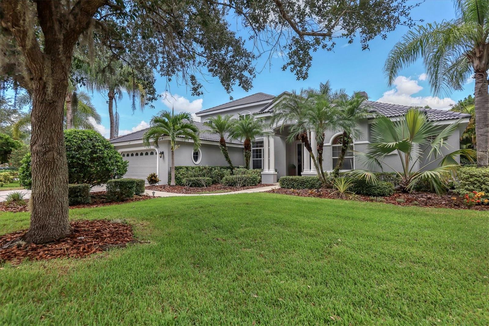 Welcome to the Sanctuary in The River Club. This fabulous home boasts 4 bedrooms, 3.5 Bathrooms, an office, a large bonus room, and much more. Nestled on a beautiful lot with lush mature landscaping, the home's surroundings create a near-perfect setting of tranquility and privacy. This Todd Johnston Weldon III model has had many recent updates inside and out including HVAC units, landscape lighting and irrigation, garage doors, a new pool pump and pool surface, bathroom renovations, and all new wood-look plank tile flooring on the first floor. Upon entry, the welcoming dining and adjacent living room are light and bright and feature a large window, a fireplace, built-in shelving, and sliding doors that lead to the lanai and pool area. The kitchen is completely open to the family and features granite countertops, stunning white cabinetry with ample storage, stainless steel appliances, a gas cooktop, and a breakfast nook with aquarium windows and a door to the lanai. Adjacent to the kitchen is a large pantry and built-in workspace as well. The family room includes a built-in media center and large banks of windows and doors to create an amazing indoor/outdoor entertaining space. The owner's suite is located on the first floor and includes a private sitting area with large double doors, a customized walk-in closet with built-in shelving, and a large island with additional storage. The bathroom has dual vanities with separate makeup vanity, a large tub, and a spectacular walk-in shower. Also on the first floor are two guest rooms, a half bathroom, another full bathroom, and the office. The office has private double doors with views of the sanctuary. The second floor features a large bonus room perfect for a gym, game room, or media room and includes brand new carpeting and large windows with serene sanctuary views. In addition, there are two bedrooms and one full bathroom. Sit back and relax by the heated saltwater pool in the large lanai and admire the peaceful views of the sanctuary. There is even a private pool bathroom for added convenience. This home has everything you could imagine and more, perfect for a family looking to live in Lakewood Ranch. The River Club is also near Braden River elementary and middle school and conveniently located near I-75, Lakewood Ranch main street, shopping, dining, nature trails, and more. The River Club has a beautiful 18-hole golf course that is privately owned and operated, and open to the public. The River Club amenities include a lavish clubhouse, tennis courts, a community pool, and more. You won't want to miss this stunning Lakewood Ranch home!