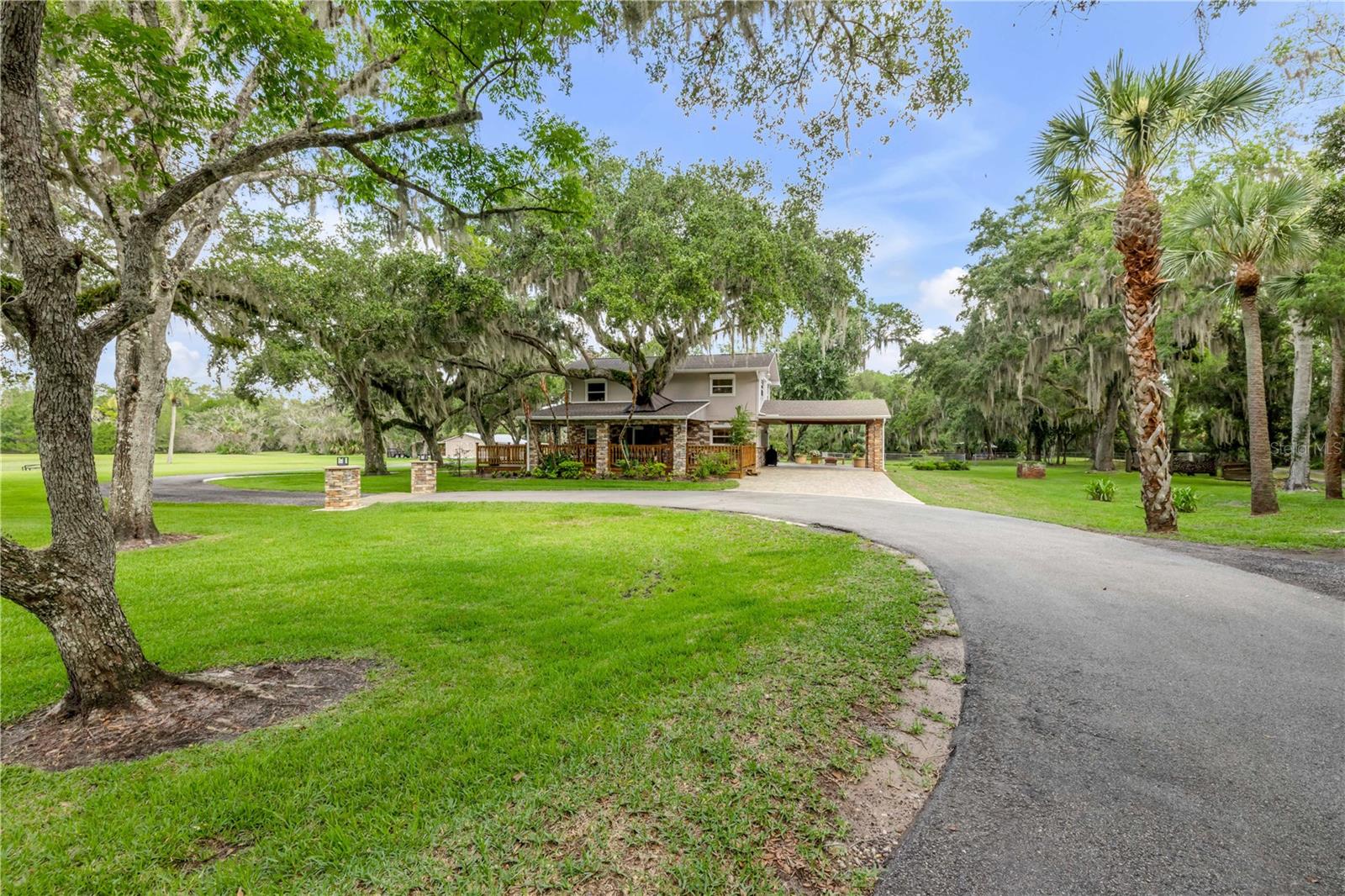 Tucked away on more than 35 breathtaking acres in the heart of Oak Hill, this one-of-a-kind country estate offers the perfect blend of privacy, modern comfort, and endless opportunity. Whether you've been dreaming of a family compound, equestrian property, weekend retreat, or simply room to breathe, this is the kind of property that rarely becomes available.
A private, approximately three-quarter-mile driveway welcomes you home, creating a peaceful setting surrounded by nature where you'll feel miles away from everything—while still being just a short drive to New Smyrna Beach, boating, shopping, and everyday conveniences.
The beautifully updated 4-bedroom, 3-bathroom home has been thoughtfully renovated while maintaining its timeless country charm. Inside you'll find multiple living spaces designed for gathering with family and friends, including a spacious loft, a cozy family room with a wood-burning stove, and a formal living room centered around a classic fireplace. Every space feels warm, inviting, and ready to make memories.
Step outside and enjoy the Florida lifestyle from the expansive covered front and back porches, where peaceful mornings and stunning sunsets become part of your daily routine.
The true showstopper is the land. With approximately 27 cleared and usable acres, stocked ponds, a winding creek, and wide-open space in every direction, the possibilities are endless. Bring your horses, ATVs, boats, RVs, or simply enjoy the privacy and beauty that comes with owning a property of this size. As larger acreage becomes increasingly difficult to find in Central Florida, this estate also represents an incredible long-term investment opportunity.
Additional features include a detached guest house that's perfect for extended family, guests, a home office, or future rental potential, along with a 36' x 24' barn with covered extensions totaling approximately 36' x 54', providing plenty of room for equipment, hobbies, animals, or storage. The property also includes a future homesite with electricity already in place, making it ideal for creating a true multi-generational family compound.
If you've been searching for a property that offers space, privacy, freedom, and endless possibilities without sacrificing convenience, this is it. Opportunities like this don't come around often.
Schedule your private showing today and experience everything this incredible Oak Hill estate has to offer.