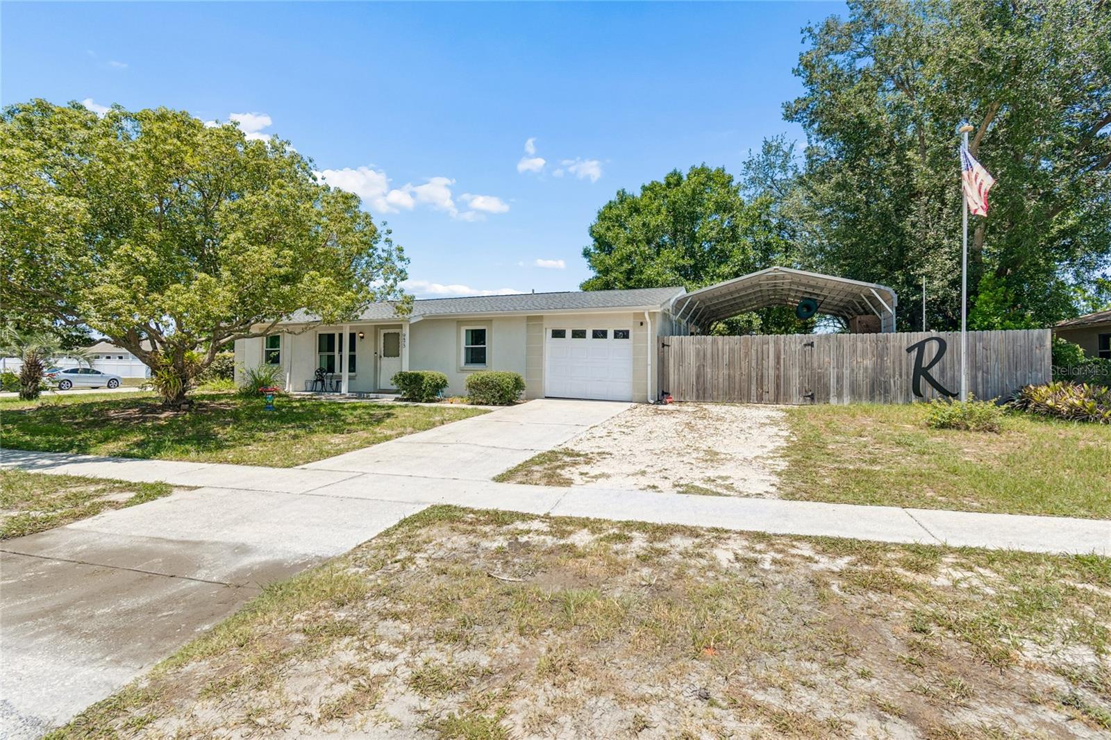 Welcome to your ideal Florida retreat! This charming 2-bedroom, 2-bathroom home offers comfortable indoor and outdoor living with an updated galley kitchen featuring stainless steel appliances and durable tile flooring throughout. The spacious open-concept living and dining areas create an inviting atmosphere perfect for everyday living and entertaining. The enclosed porch provides valuable flex space that can be utilized as a home office, hobby room, guest area, fitness space, or additional living area. Step outside to your private backyard oasis featuring an above-ground pool, covered patio perfect for grilling and entertaining, and a large fully fenced yard with plenty of room for pets, play, gardening, or creating your own outdoor retreat. Need room for your toys? The oversized detached carport provides ample space for a large boat, RV, or additional vehicles. Major updates include a new roof in 2021 and A/C in 2019 for added peace of mind. Conveniently located near shopping, restaurants, medical facilities, and everyday conveniences, this move-in-ready home offers the perfect blend of comfort, functionality, and Florida lifestyle living.