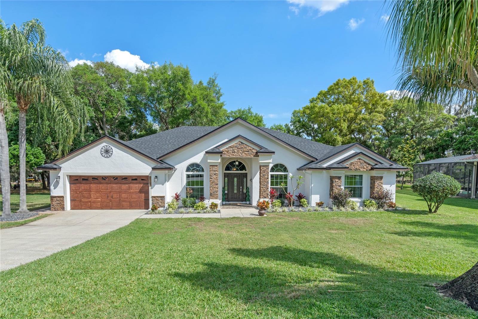 **Love the Lake Life?  Welcome to this beautiful 4 bedroom/ 3 bath canal lake home located on the Clermont Chain of Lakes, specifically on the stunning connected Lake Minnehaha, well known for being an excellent playground for water sports and recreation. This property offers a NEW private dock with a NEW boat lift, motor, cradle & side screens, lighting and surveillance cameras, all perfect for storing a boat.  The backyard is the GEM in this home, featuring a cozy fireplace, pavers, outdoor lighting, setting the perfect ambiance for intimate gatherings and all protected with a NEW seawall.  Enjoy grilling and entertaining on the NEW luxury Paradise Grills Monaco Series outdoor kitchen grill island & island bar, featuring the state-of-the-art appliances.   Create lasting memories with family and friends around your own backyard outdoor retreat. Mini Split AC in the Garage.  NOTE:  "available fully furnished 

This home is nested in a cul-de-sac in one of the best Lake County areas in Clermont (county boundary) away from everything and close to shopping.  As you enter the home you are greeted with the natural light, an open floor plan seamlessly combining the living, dining, and kitchen areas, creating an open space for entertaining.  Windows are impact with a transfer lifetime warranty.  Fresh coat of paint inside and outside with upgraded landscaping, including a NEW roof just installed in March 2024. All the Stainless-Steel appliances are less than a year old. New laundry room with commercial grade washer and dryer.  Too many upgrades to mention…

With private dock access from the backyard, offering effortless access to enjoy boating, fishing, skiing, wakeboarding, paddle boarding, kayaking, lounging, or simply a sunset cruise to grab dinner in downtown Clermont, this home will provide an excellent opportunity to experience lakeside luxury living.  

Recent upgrades in the last 2 years:  Mini Split AC in the Garage, New Roof, Seawall, Spa, Boat House, boat doc floor boards,2 40-50’ tress next to the house, outdoor kitchen, Sonos-Yamaha outdoor sound system & updated camera’s.  The Sunchaser 2016 Tritoon with a 250 shown on the boat lift can be sold separately if interested with trailer.