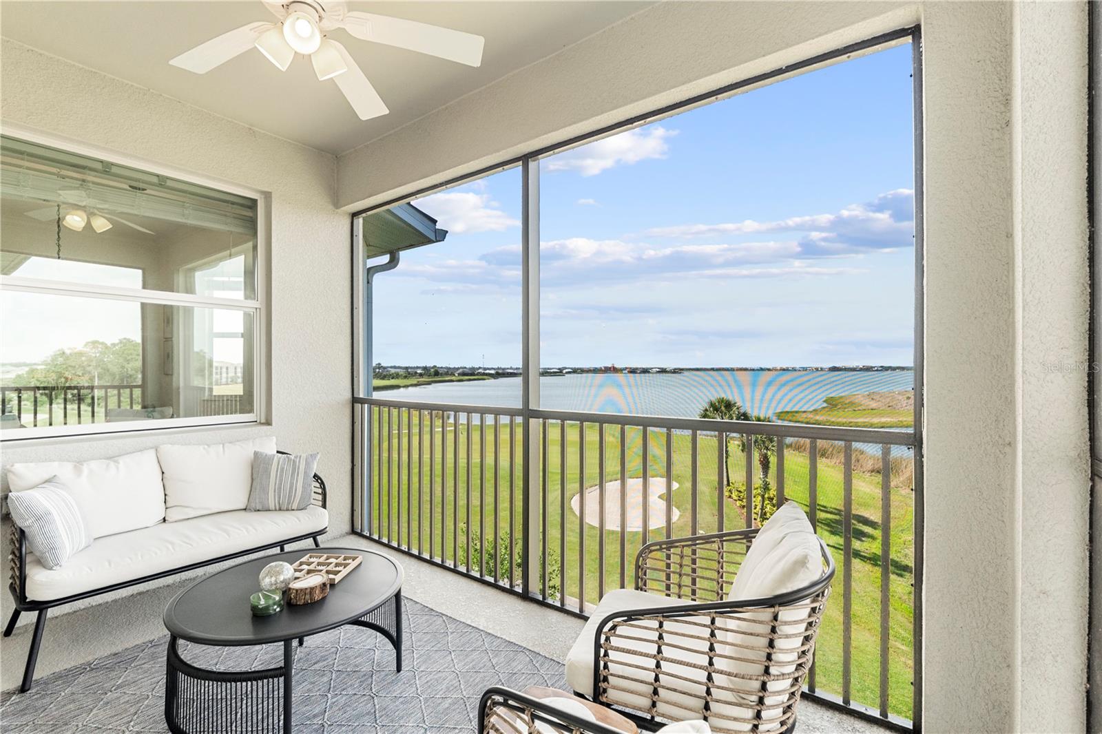 Enjoy penthouse living with breathtaking views overlooking the largest lake in Babcock Ranch and the 10th green of the Babcock National Golf Course. This rare top-floor end unit offers exceptional privacy and comes with bundled golf, making it a highly sought-after opportunity.
This light-filled residence features 2 bedrooms and 2 full baths with an open-concept floor plan where all main living areas capture stunning water and golf course views. The spacious kitchen includes granite countertops, a breakfast bar, and a dining area wrapped in windows, creating a bright and inviting space for everyday living and entertaining. The living area opens to a screened lanai, perfect for relaxing while overlooking the serene surroundings.
Interior finishes include tile flooring in the main living areas, plush carpet in the bedrooms, designer lighting throughout, and blinds on all windows. The primary suite offers a generous walk-in closet, dual-sink vanity, a luxurious walk-in shower, and a separate linen closet. The second bedroom and adjacent full bath are ideal for guests or family.
Babcock National is a premier resort-style community, anchored by its 18-hole championship golf course designed for players of all skill levels. Residents enjoy tennis and pickleball courts, bocci ball, a lively Tiki Bar, the newly opened Clubhouse and Enclave restaurant, two resort pools (including a lap pool), whirlpool spa, steam room, on-site spa services, and a state-of-the-art fitness center with classes.
Community life is vibrant with gourmet food trucks, live music, art shows, and farmers markets. Convenient shopping and dining are just minutes away at the Publix shopping center and nearby favorites including Starbucks, Five Guys, Marshalls, Ace Hardware, Ulta, Panera Bread, Carvel, nail and aesthetics studios, and the popular Oak & Iron restaurant, along with sushi, Mexican, and pizza options. Even more is on the way with the B Street Shops opening in late 2026.
Babcock Ranch is more than a place to live—it’s a lifestyle. This one-of-a-kind terrace condo with spectacular views is not to be missed. Welcome home.