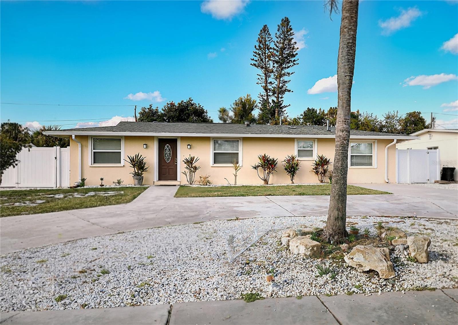 This inviting home features a spacious open floor plan with tile flooring throughout and a large Florida room that fills the space with natural light. NO HOA, NO CDD. The private, fully fenced backyard serves as a tropical oasis, complete with a sparkling pool and hot tub, while the primary suite offers convenient direct access to the pool deck. Perfectly situated for outdoor enthusiasts, the property is just minutes from the recreational amenities at G.T. Bray Park, IMG Sports academy, and a short drive to the pristine sandy beaches of Bradenton Beach and Anna Maria Island. Major shopping centers are just a few blocks away. Located in a quiet and friendly neighborhood. This property is currently a successful short-term vacation rental on Airbnb with a 4.8-star rating, offering an incredible opportunity for an immediate primary residence or a high-performing investment. No flooding issues. No hurricane damage. Peace of mind is built-in with several recent high-value upgrades: Roof (2022), Water Heater (2025), Pentair Pool Automation (2025), Outdoor Firepit (2025), Refrigerator (2026), Oven (2026), renovated master bathroom, and Two On-Site Storage Sheds.