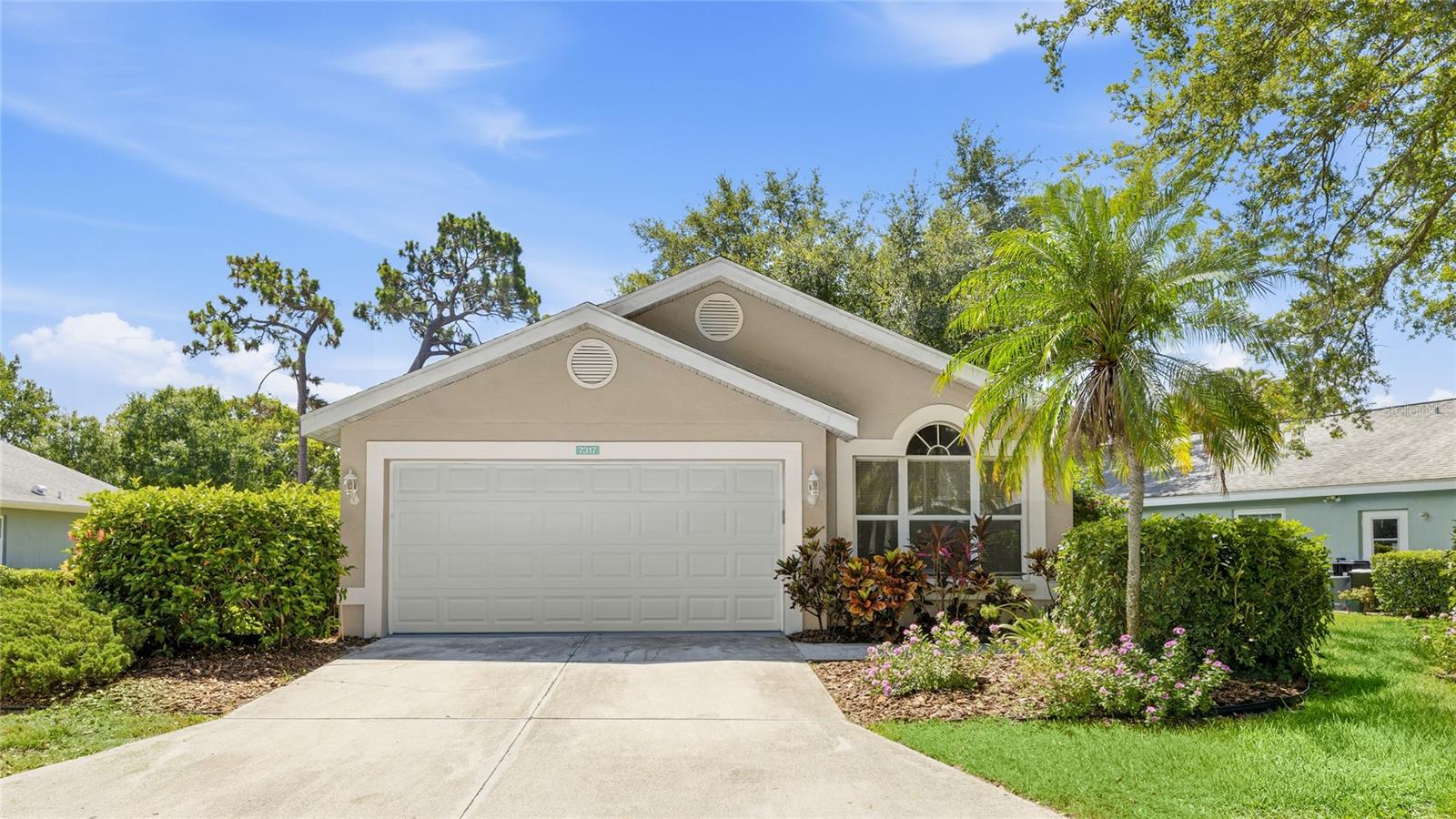 Virtually Staged. Welcome to a home where the view does the talking. Set on a peaceful pond in the established Sarasota neighborhood of Pinehurst, this single-story retreat trades the ordinary for tranquil water, gliding herons, and the kind of quiet that is hard to find this close to everything. The heart of the home is its light. Vaulted ceilings rise over warm wood-look floors and freshly painted, neutral walls, carrying you through an open great room and into a bright white kitchen finished with granite counters, plenty of cabinetry, and a breakfast bar made for easy gatherings. Every path seems to lead to the showstopper out back, a glass-enclosed Florida room that runs the full width of the home, climate-controlled for year-round enjoyment and framing the pond and its wildlife through wall-to-wall windows. When the day winds down, the owner's suite offers the same calming water view and a private bath with a walk-in tiled shower. Two more bedrooms, a second full bath, and an interior laundry closet round out a layout that lives larger than its footprint. Beyond the door, low HOA fees handle the lawn and common areas, the roof was updated around 2020, and the Gulf Coast is calling. You are minutes from University Town Center, I-75, downtown Sarasota and Bradenton, SRQ Airport, and some of Florida's most beloved beaches. **THIS PROPERTY QUALIFIES FOR A 1% LENDER INCENTIVE IF USING PREFERRED LENDER. INQUIRE FOR MORE DETAILS.**
