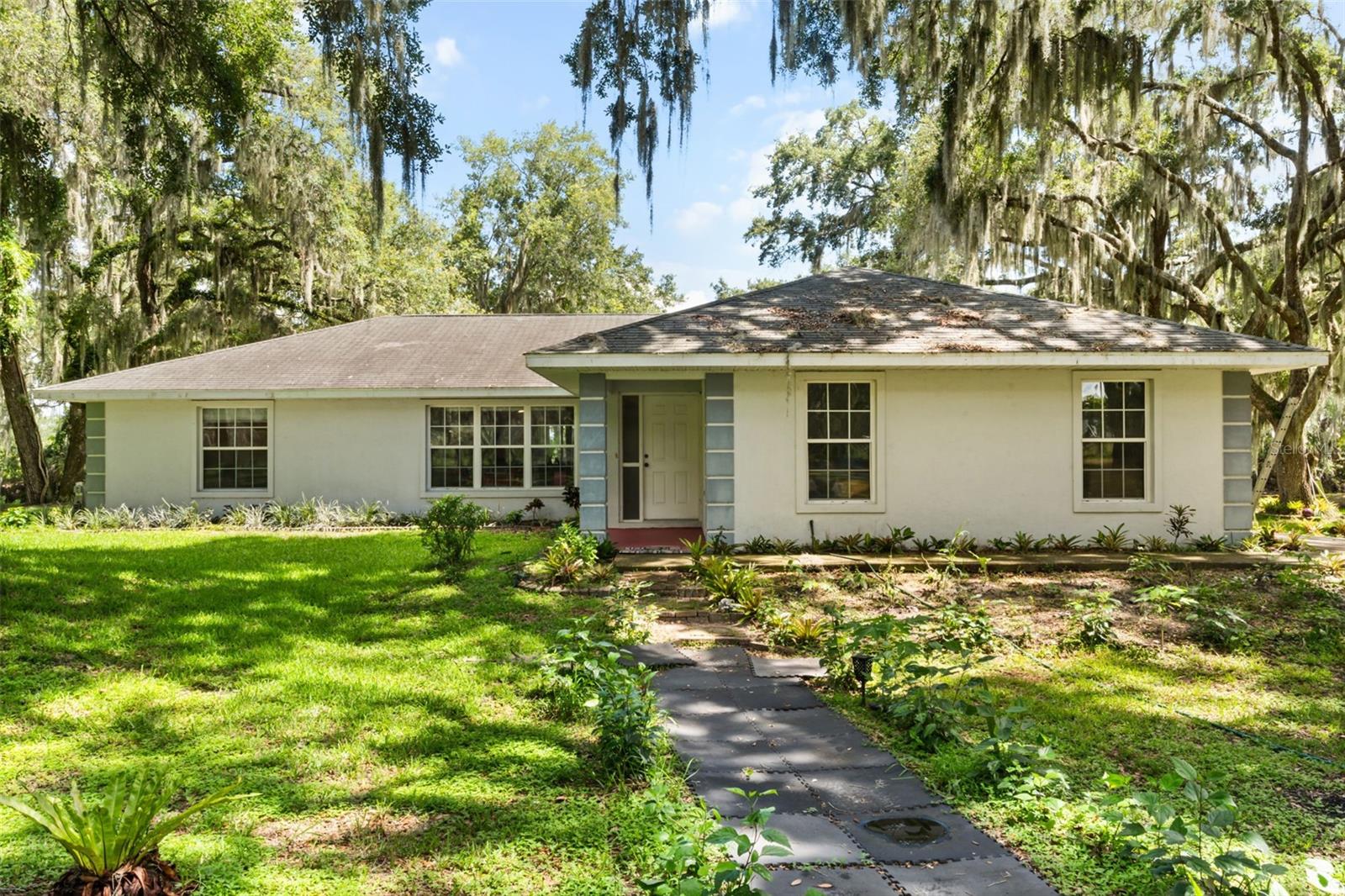 2.6 ACRE CANAL FRONT - HARRIS CHAIN OF LAKES - NO HOA - NEWER HVAC SYSTEM - Bring the boat. This 2.3 ACRE CANAL FRONT retreat in Jacksons River Country Estates puts you a few steps from your own private boat launch with direct access to the HARRIS CHAIN OF LAKES, a network of over 70,000 connected acres perfect for fishing, sunset cruises, and weekend adventures with no boat ramp lines and no storage fees ever again. The 3 bedroom, 2 bath home sits on a rare oversized lot with NO HOA, so there is real room to store the boat, the RV, the trailer, or the workshop you have always wanted, plus an oversized 21x21 attached garage for even more space. Wake up to water views, launch from your own backyard in minutes, and come home to the kind of privacy that is getting harder to find in Lake County. Homes with this much acreage this close to the Chain of Lakes do not come along often, and the ones that do not last. Schedule your private showing before someone else finds it first.
