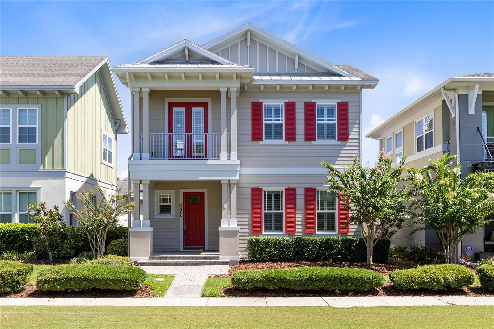 Set along one of Laureate Park’s beautifully manicured green spaces, this timeless Craftsman-style home has been thoughtfully refreshed and is completely move-in ready. Featuring newly renovated flooring, beautifully updated bathrooms, fresh interior and exterior paint, and a desirable first-floor primary suite, this residence blends classic charm with modern style in one of Lake Nona’s most sought-after communities.

A welcoming front porch, striking red front door, and second-story balcony create unforgettable curb appeal, while inside, 2,016 heated square feet offer bright, open living spaces filled with natural light. Soaring ceilings and the home’s fresh updates create a warm, inviting atmosphere from the moment you step inside.

The heart of the home is a beautifully appointed kitchen designed for everyday living and entertaining, complete with a large center island, stone countertops, stainless steel appliances, pendant lighting, abundant cabinetry, and a spacious pantry. The dining area and great room flow seamlessly together before opening through French doors to the screened lanai, creating the perfect indoor-outdoor living experience for relaxing or hosting family and friends.

Privately located on the first floor, the primary suite serves as a peaceful retreat with a spacious walk-in closet and a beautifully updated spa-inspired bathroom featuring dual vanities, stone countertops, a soaking tub, and a separate glass-enclosed shower.

Upstairs, a versatile loft opens onto the covered balcony overlooking the picturesque neighborhood green space, making it the perfect spot for morning coffee, evening sunsets, a home office, or a cozy reading nook. Two additional bedrooms and a full bathroom complete the second level, providing flexible space for family, guests, or hobbies.

A rear-entry two-car garage and private driveway enhance both functionality and curb appeal.

Beyond the front door, Laureate Park offers an unmatched lifestyle with resort-style amenities including the Aquatic Center, multiple pools, LP Fit fitness center, parks, playgrounds, community events, and more than 44 miles of scenic walking and biking trails. You’ll also enjoy being just minutes from Medical City, Nemours Children’s Hospital, the VA Medical Center, USTA National Campus, Orlando International Airport, premier dining and shopping, major highways, world-famous attractions, and Florida’s beautiful beaches.

With extensive recent updates, an exceptional floor plan, and an unbeatable location, this beautifully renovated home offers the perfect opportunity to experience the best of Lake Nona living.