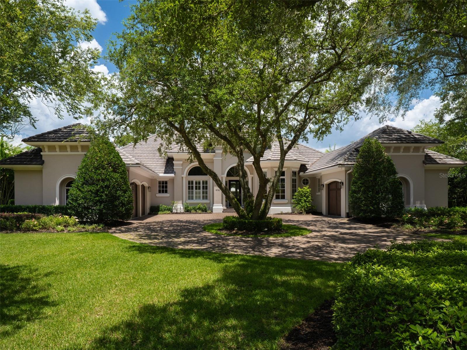 Perfectly positioned on the 13th hole in the prestigious community of Golden Ocala, this elegant residence offers refined living with exceptional privacy and breathtaking outdoor spaces. Lush, mature landscaping surrounds the home, creating privacy highlighted by a stunning pool and spa set within an expansive brick paver deck. Flooded with natural light, the interior seamlessly blends indoor and outdoor living. Expansive sliding glass doors fully retract to open onto covered entertaining areas, making this home ideal for hosting gatherings or enjoying Florida’s year-round sunshine. High tray ceilings and thoughtfully designed spaces enhance the home’s bright interior and showcase beautiful golf course views. The residence features 5 bedrooms, 3.5 bathrooms, and a gorgeous private study. The beautiful kitchen is complete with updated appliances, a butler’s pantry, solid wood cabinetry, and abundant counter space for effortless entertaining. Additional highlights include a gas fireplace in the living room, a stylish dry bar, and an outdoor grill. A circular drive and split three-car garages provide both convenience and impressive curb appeal. Enjoy the lifestyle Golden Ocala offers, with world-class amenities including the clubhouse, restaurants, championship golf, tennis, spa, barns, and the renowned World Equestrian Center. This is luxury living at its finest, private, polished, and perfectly positioned.