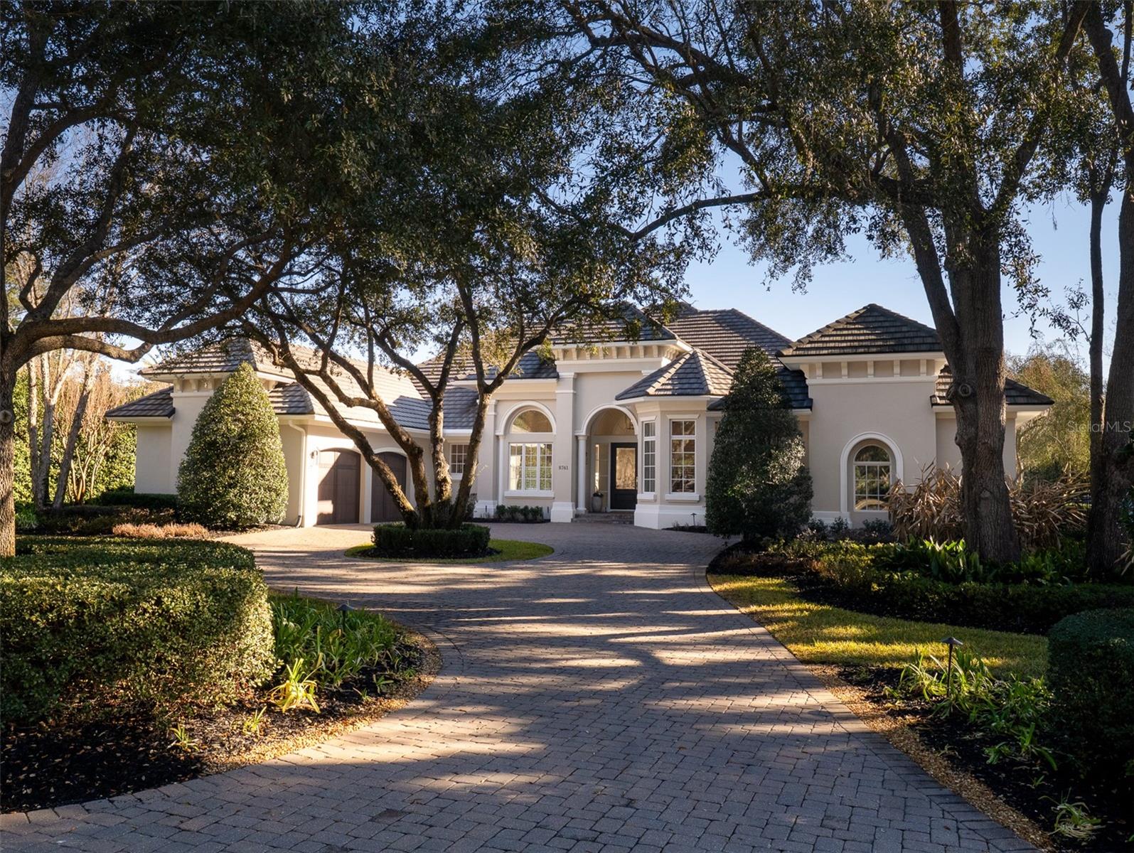 Perfectly positioned on the 13th hole in the prestigious community of Golden Ocala, this elegant residence offers refined living with exceptional privacy and breathtaking outdoor spaces. Lush, mature landscaping surrounds the home, creating privacy highlighted by a stunning pool and spa set within an expansive brick paver deck. Flooded with natural light, the interior seamlessly blends indoor and outdoor living. Expansive sliding glass doors fully retract to open onto covered entertaining areas, making this home ideal for hosting gatherings or enjoying Florida’s year-round sunshine. High tray ceilings and thoughtfully designed spaces enhance the home’s bright interior and showcase beautiful golf course views. The residence features 5 bedrooms, 3.5 bathrooms, and a gorgeous private study. The beautiful kitchen is complete with updated appliances, a butler’s pantry, solid wood cabinetry, and abundant counter space for effortless entertaining. Additional highlights include a gas fireplace in the living room, a stylish dry bar, and an outdoor grill. A circular drive and split three-car garages provide both convenience and impressive curb appeal. Enjoy the lifestyle Golden Ocala offers, with world-class amenities including the clubhouse, restaurants, championship golf, tennis, spa, barns, and the renowned World Equestrian Center. This is luxury living at its finest, private, polished, and perfectly positioned.