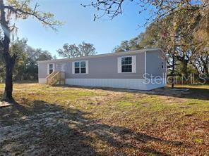 One or more photo(s) has been virtually staged. NEW CONSTRUCTION on 1.67 Acres – Peaceful Country Living! Welcome to this brand-new manufactured home offering 1,468 sq ft of thoughtfully designed living space with a bright, open floor plan perfect for modern living. Enjoy the freedom and privacy of 1.67 acres, giving you plenty of room for outdoor activities, gardening, or simply relaxing in your own peaceful retreat. This property also features a 24x24 workshop equipped with electricity and plumbing, making it ideal for a home business, hobbies, storage, or future customization. Located in Williston, this home offers the best of both worlds—peaceful country living just 10 minutes from grocery stores and gas stations. Perfectly positioned between Ocala and Gainesville, you’ll enjoy convenient access to shopping, dining, and entertainment. Outdoor enthusiasts will love being just minutes from the world-famous Devil's Den Prehistoric Spring, a unique natural attraction for swimming and diving. No HOA. No CDD. Bring your toys, RV, or animals—this property offers the flexibility and space you’ve been searching for. Don’t miss this opportunity to own a beautiful new home with land, functionality, and location all in one!