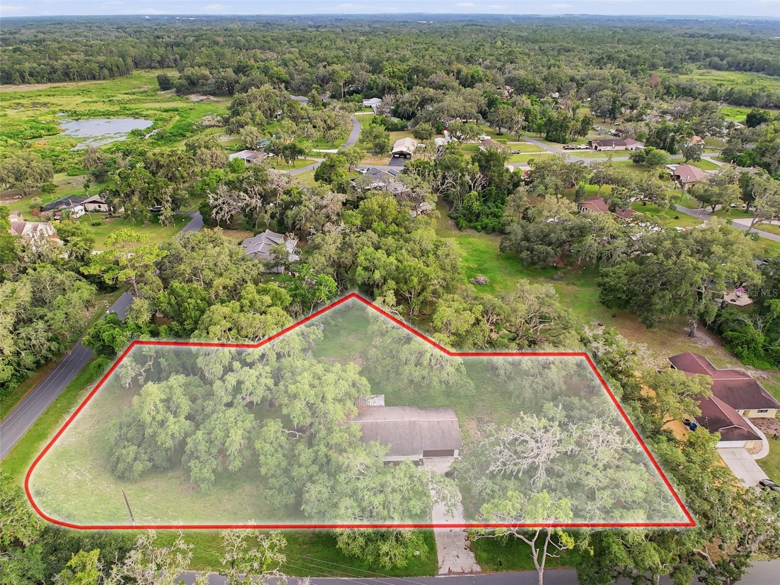 Opportunity awaits on this rare triple lot totaling approximately 1.05 acres in Lakewood. The existing home sustained flood damage and is being sold for land value. With three separate lots included, buyers have the potential to subdivide (subject to county approval), making this an excellent investment, redevelopment, or new construction opportunity. Enjoy plenty of space for your dream home, additional homesites, or future expansion in a convenient location with easy access to I-75, Dade City, Brooksville, and surrounding areas. Whether you're a builder, investor, or someone looking for acreage with development potential, this property offers endless possibilities.