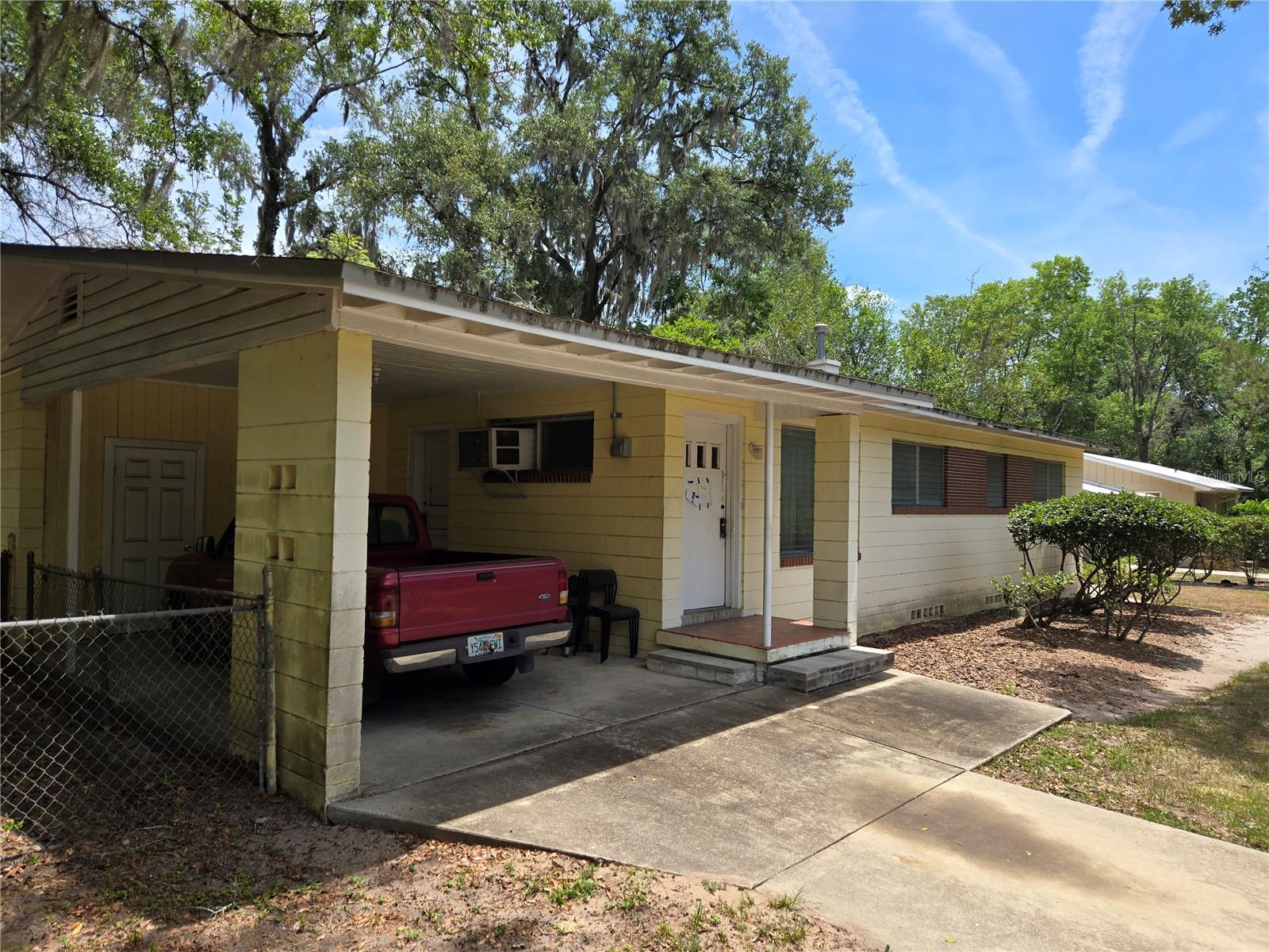 This is a three bedroom two full bath hidden gem of a house, full of potential to make a great home.  It sit in an in-demand, centrally located in Gainesville, close enough to the University for a short bike ride, 4 blocks to Publics supermarket and tons of other shops and eateries, such as Mi Apa.   The house has original hardwood floors that can be brought back to light with a coat of polyurethane.  The kitchen has original solid wood cabinets; the backyard is completely fenced in.  The house is made of cement block, making it ideal for keeping the place cool in the morning hours and retaining any air conditioning.  Lastly, there is a convenient carport to keep you dry if it's raining.     Easy to see.