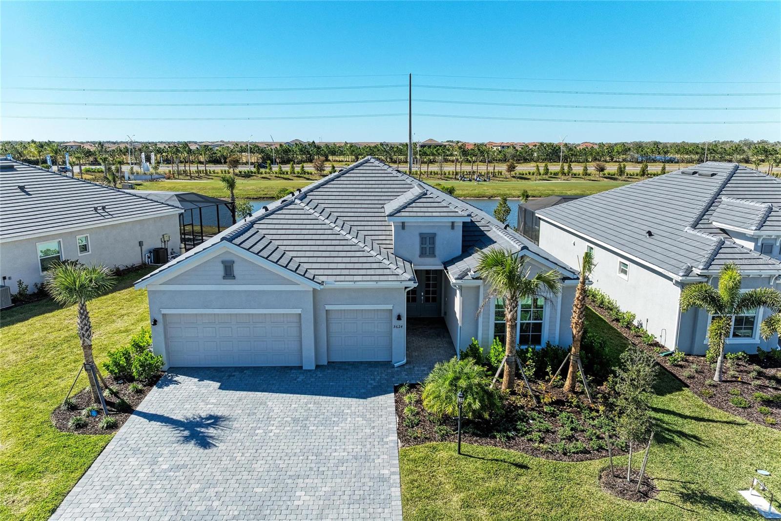 READY MOVE-IN HOME WITH LAKE & GOLF COURSE VIEWS!  Welcome to Calusa Country Club, a premier golf and resort-style community where luxury living meets the Florida lifestyle in the #1 Master-Planned award-winning LAKEWOOD RANCH, FL. Lennar's Newest Golf community with a bundled full golf membership included with your HOA, offering unlimited access to two Gordon Lewis–designed championship golf courses, that are ready to golf!
This stunning Summerville single-story floor plan showcases incredible lake/golf course views and has the perfect blend of elegance, comfort, and functionality. The spacious home features 3 bedrooms, 3 full bathrooms, a private den/office with French glass doors, with a designer feel throughout. The 3-car garage-with beautiful custom epoxy floors provides extra storage for golf carts, hobbies, or versatile needs.
The open-concept living area flows effortlessly into the heart of the home—an upscale chef’s kitchen featuring gas cooktop with hood, elegant quartz countertops, stainless steel appliances, an oversized island, and designer finishes. Porcelain Tile flooring throughout enhances the modern, airy feel. Sliding glass doors lead to an oversized screened lanai, ideal for indoor-outdoor entertaining.
Your luxurious owner’s suite offers private lanai access, dual sinks with upgraded faucets,  a large walk-in shower, and two sizable walk-in closets. A split floor plan ensures privacy with a secondary suite and an additional guest bedroom, each with its own full bathroom. 
Step outside your spacious Lanai and unwind by your private heated pool and spa, perfectly positioned to enjoy your tranquil lake view with birds in the distance and golf course views after a round on the course. Home also has full home security system installed and surround sound speaker system.
Residents of Calusa Country Club enjoy a top-notch array of resort-style amenities, including a full-service restaurant, bar, resort pool, fitness center, tennis and pickleball courts, bourbon bar, putting course with tiki bar, and more—many coming soon, while courses are open.  Whether you're hitting the fairways, savoring a meal at the club, or relaxing poolside under the Florida sun, life is undeniably great at Calusa.
Ideally located near Lakewood Ranch Main Street and three town centers, residents enjoy easy access to premier shopping, dining, entertainment, and everything this coveted location enjoys.
 Don’t miss your chance to live in one of Lakewood Ranch’s most exciting new resort communities—schedule your private showing today.
