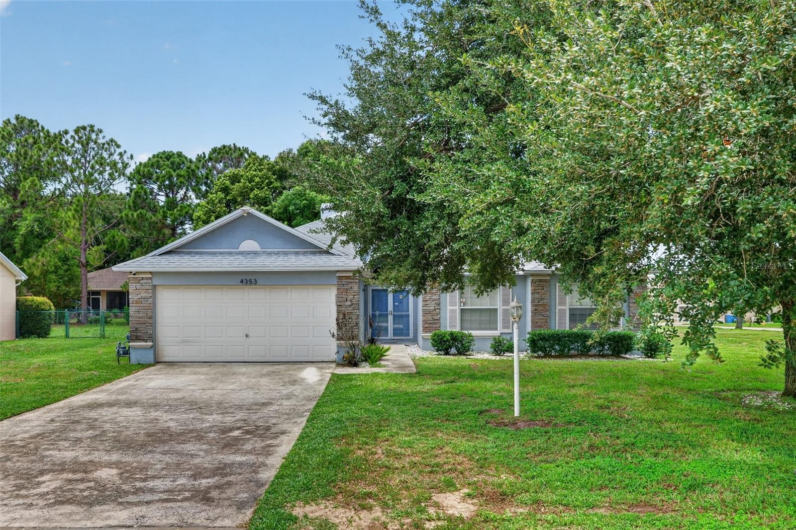 4-bedroom, 2-bath home nestled on a generous 0.34-acre corner lot in the desirable Dinner Lake community of Lake Wales! Offering 1,678 square feet of comfortable living space, this home features an inviting open floor plan with soaring vaulted ceilings, abundant natural light, and a cozy fireplace that creates the perfect gathering space. The kitchen overlooks the main living area, making entertaining effortless. Enjoy year-round relaxation in the large screened lanai, ideal for morning coffee or evening get-togethers while overlooking the expansive backyard. The oversized lot provides plenty of room for pets, play, or future outdoor enhancements. A two-car garage, mature landscaping, and attractive curb appeal complete the package.