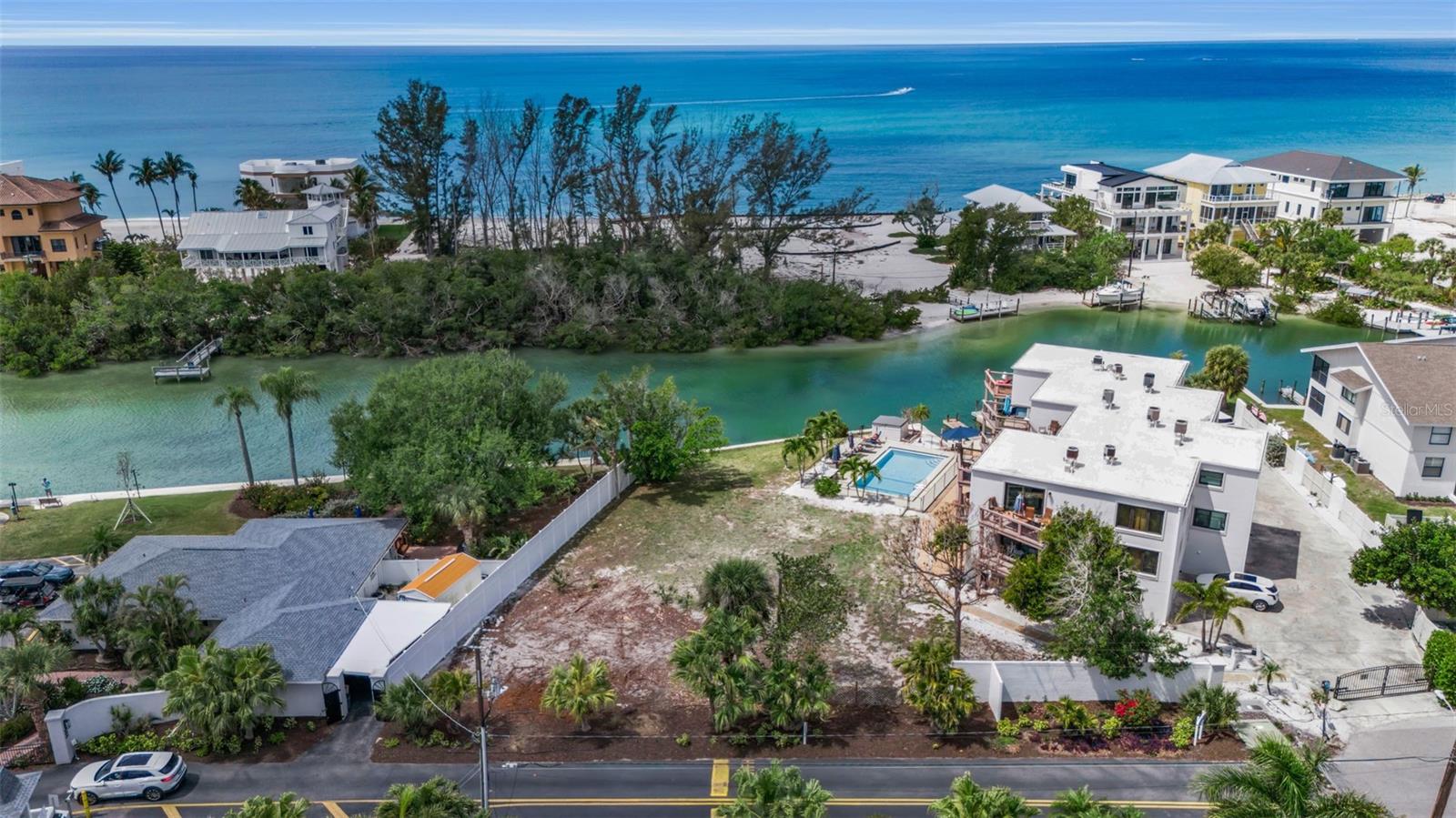 A rare offering on the south end of Siesta Key, this 0.25-acre waterfront lot on Blind Pass delivers an exceptional canvas for coastal living and development. With protected water frontage and direct access leading out to Sarasota Bay, the location is ideal for enjoying the area’s incredible boating, fishing, kayaking and the breathtaking sunsets that paint the sky each evening. Zoned RMF 3, the seller has architectural plans for a 3-unit condo building of two 1-story flats and one two-story unit. Property offers outstanding flexibility, whether you envision a multi-residence project, luxury townhomes, or creating an island paradise ideal for a family vacation compound. Just three minutes from world-famous, white-sand Siesta Key Beaches, this site also provides convenient access with a short drive to Siesta Key Village, known for its shopping and dining. Only a bridge away from the mainland, you’re close to all Sarasota has to offer, including cultural venues, marinas and urban conveniences. A standout waterfront opportunity in one of Sarasota’s desirable coastal corridors.