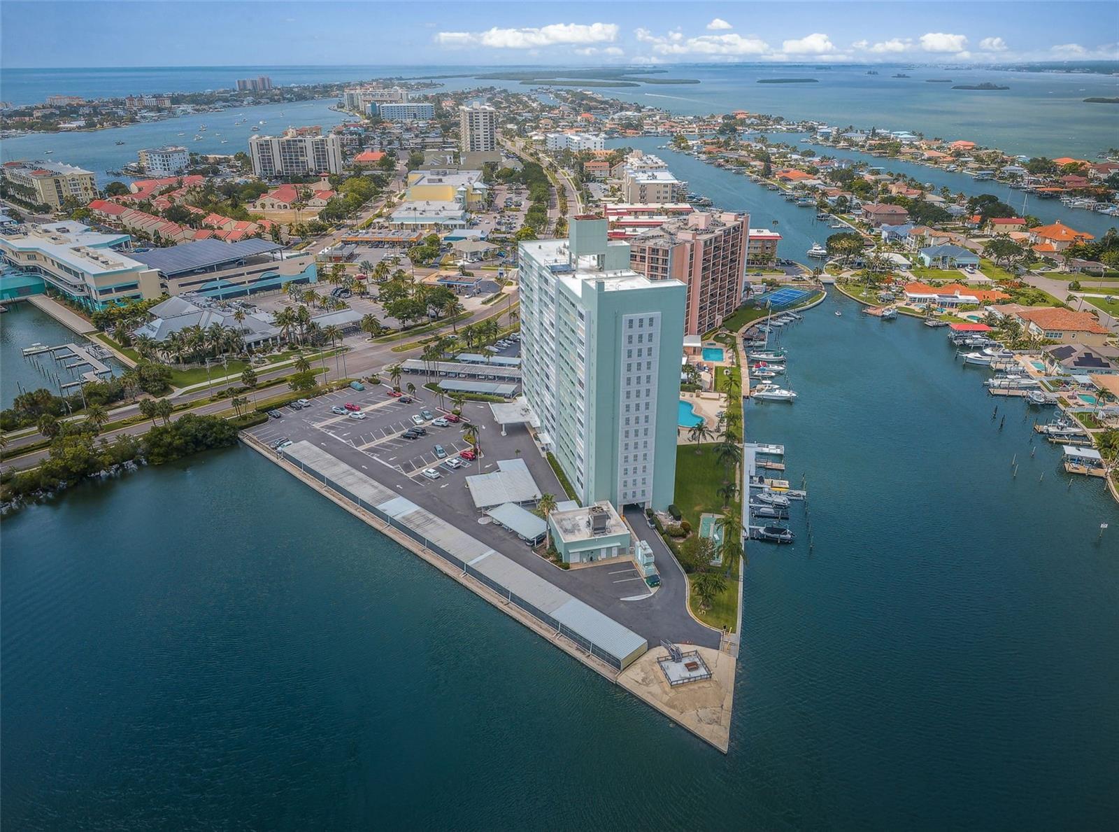 Start living 2026 on the ISLAND!  Whether it's your primary home or second home you won't find views any better than here!  And only minutes to the white sandy beach of Clearwater offering dining, shopping and laid back fun!  Island Estates is one of the most sought-after enclaves in the Clearwater Beach region. Comprising four islands and a charming retail area that includes a unique Publix market and a variety of shops, it also features the amazing Clearwater Marine Aquarium, neighborhood eateries including the famed Island Way Grill. Seconds from the Clearwater Memorial Causeway and minutes from one of the most beautiful beaches in the world, biking and running trails, as well as Imagine Clearwater, the newer 24-acre waterfront park/plaza with covered amphitheater, this one-time hurricane shelter was purchased by residents in the early 1960s to create a distinctive dwelling. Nestled on the intracoastal, off Florida’s mainland, a panoramic water landscape lends the shoreline experience to this lovely 1 bedroom/1 bath home. The amenity-rich building includes private storage closets off every hallway to accommodate seasonal décor and supplies, complimentary laundry rooms on each floor, boat slips on a first come first serve basis with an additional monthly fee, bike storage, a glistening geo-thermal heated pool framed by chaises, a fishing pier, grilling stations, and The Point: a waterfront structure that offers yet another tranquil place to unwind. An incredibly spacious lobby boasts comfy furniture, views of the pool, a secure package room, a lending library, a community kitchen, and a huge multi-purpose meeting room. A variety of clubs and activities are run by residents while several committees are available to feed your volunteer's soul. Impeccably managed by its full-time, onsite property manager and staff, the monthly fees include basic cable, lobby Wi-Fi, electric, water, sewer, trash, and building maintenance. The dedicated board of directors have initiated some tremendous cost savings and improvements to benefit the shareholders’ investment including energy efficient boilers, upgraded A/C and elevators, NEWER fitness center, NEWER entry security, and NEWER Miami Dade spec windows on the lobby level. Inside this cozy unit on the sixth floor, walk into the “wow factor” where floor to ceiling sliders reveal dramatic water vistas.
