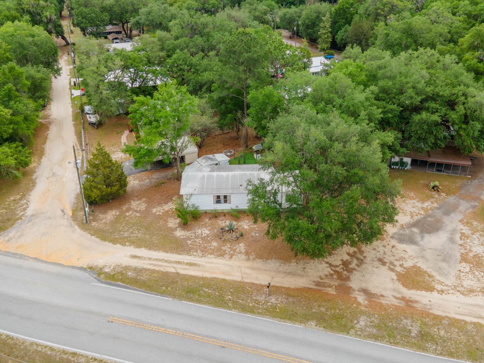 Lake Kerr Canal Home with OHV Access – 21220 E Hwy 316, Salt Springs, FL 32134
2 Bedrooms | 1.5 Bathrooms | 912 Sq Ft | .19 Acre | Updated | Forest Access

Welcome to this affordable waterfront getaway located on a canal leading to Lake Kerr, right in the heart of Salt Springs and the Ocala National Forest. Situated on a .19-acre lot on a paved road, this property offers the perfect combination of outdoor recreation, convenience, and peaceful living.

Directly across the street, you’ll find Ocala National Forest access with miles of OHV trails, making this an ideal home for ATV/UTV enthusiasts, hunters, and nature lovers.

The 1970 mobile home features 2 bedrooms, 1.5 bathrooms, and 912 sq ft of living space. Inside, you’ll find laminate flooring throughout and an updated kitchen with stainless steel appliances, creating a clean and modern feel. Major systems have been improved, including an HVAC system less than 5 years old and a new hot water heater (2025).

Step outside to a 12’x16’ covered wood deck, perfect for relaxing or entertaining while overlooking the fenced backyard. A 12’x10’ storage shed provides additional space for tools, equipment, or outdoor gear.

The property sits on a canal that leads to Lake Kerr (currently dry due to drought conditions). Lake Kerr is a 2,800-acre spring-fed lake, the second largest in Marion County, known for excellent fishing, boating, and water recreation. It also connects to Little Lake Kerr (Lake Werner) for expanded exploration.

Located in the heart of the Ocala National Forest, you’re just minutes from the Salt Springs Recreation Area, Lake George, and the St. Johns River, offering endless opportunities for fishing, boating, kayaking, hiking, horseback riding, and off-road adventures.

Conveniently located near local shopping, dining, and essentials, and only 30 minutes to Ocala or Palatka.

This is a great opportunity for a weekend retreat, rental, or full-time residence in one of Florida’s premier outdoor destinations.

Schedule your private showing today! Ask about Seller Financing Terms