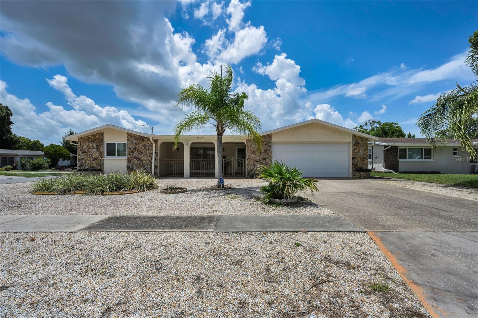 Welcome home to this charming 3-bedroom, 2-bath block home, perfectly situated on a desirable corner lot just minutes from the vibrant shops, restaurants, parks, and waterfront attractions of exciting downtown New Port Richey! Built in 1973, this well-maintained property offers fantastic curb appeal with its attractive, low-maintenance, stone-landscaped front yard and inviting covered front porch. Inside, you'll find a comfortable layout designed for everyday living, while outside, the fully-fenced backyard provides the perfect setting for pets, play, or entertaining. Relax year-round on the screened patio or enjoy additional outdoor living space under the covered patio. Practical features include a spacious 2-car garage, a water softener, and energy-saving solar panels with a transferable warranty, offering added value and peace of mind. Whether you're looking for our first home, a seasonal retreat, or your next forever home, this property combines comfort, convenience, and an outstanding location. Set up your appointment today!
