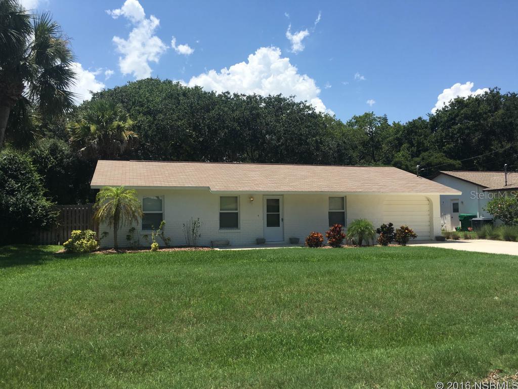 WALK TO THE BEACH! Conveniently located in-between Flagler Avenue, & 3rd Avenue making it a very desirable area in New Smyrna Beach. This 3 bedroom 2 bath cared for home has a large front yard and completely fenced in, beautifully treed back yard. All newer Windows & Slider. INTERIOR OF HOME COMPLETELY FRESHLY PAINTED IN AUGUST 2016. CARPETS PROFESSIONALLY CLEANED JULY 2016. House exterior was freshly painted & pressure washed the driveway & roof JUNE 2016. Shed in the back yard has electric and all tools are included in the sale. 1 car garage with Washer & Dryer. Big Florida room with Cable TV and AC Wall Unit. The perfect beach getaway! ;Water: City