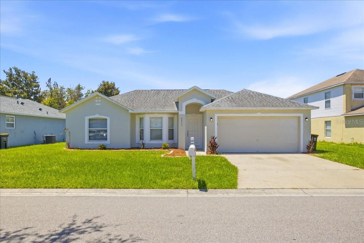 Virtually Staged. Welcome to this updated 4-bedroom, 2-bath home offering 1,750 square feet of bright, open living space in the desirable Queens Cove community of Winter Haven. Step inside to discover vaulted ceilings, abundant natural light, and an open-concept floor plan designed for comfortable everyday living and effortless entertaining. Luxury vinyl plank flooring flows throughout the house, while the spacious kitchen features granite countertops, white cabinetry, stainless steel appliances, extensive counter space, a breakfast bar, and a seamless connection to the living and dining areas. The split-bedroom layout provides added privacy, with a generous primary suite offering a walk-in closet and an en-suite bath. Three additional bedrooms provide flexibility for family, guests, or a home office. Sliding glass doors lead to the backyard with plenty of space to create your own outdoor oasis, add a pool, or simply enjoy Florida living. Additional highlights include a two-car garage, an inside laundry area, and a roof replaced in 2018 and new HVAC in 2022. Conveniently located just minutes from Legoland Florida Resort, shopping, restaurants, schools, medical facilities, and major roadways including the Polk Parkway and US-27, this home offers easy access to both Tampa and Orlando while enjoying the charm of Winter Haven's renowned Chain of Lakes. Whether you're searching for your primary residence, a second home, or an investment property, this move-in-ready home offers exceptional value in a convenient Central Florida location.