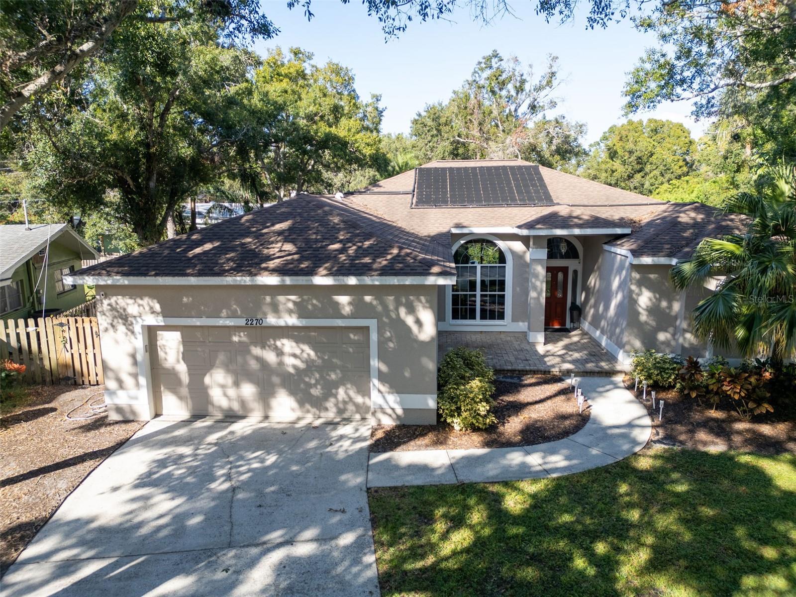 This tastefully renovated 4 bedroom, 2 bath, 2 car garage, heated pool residence is tucked away on a cul de sac in the desirable Kersey Groves neighborhood and is a successful permitted short term rental. The location is awesome, just minutes away from the top rated schools, beaches, shops and airports. This spacious home features an open floor plan, a large living room with cathedral ceilings and a cozy fireplace and a separate dining room.  The kitchen and kitchen nook are the heart of the home. The kitchen nook opens to the patio and pool via stylish french doors.  The primary bedroom is split from the other 3 bedrooms for privacy. The primary bedroom suite is awesome and has a separate sitting room/nursery/office The tastefully renovated kitchen features granite countertops, tile backsplash, soft close shaker cabinets, and newer stainless steel appliances. Both bathrooms are renovated and have a luxury spa feel. The 30 year shingle roof was installed in 2019, the a/c's in 2018/2020. The oversized lot is fenced for privacy with a heated pool (pool 2009 and heater installed 2025) and patio entertainment area and playground accessed from the living room and kitchen nook, creating a seamless blend of indoor/outdoor living. Feel like you are on vacation everyday, living the wonderful Florida lifestyle in this pristine home. There is so much natural light and room to grow in this desirable floor plan.  This chic home is centrally located close to Clearwater, airports, beach, shops, restaurants, and excellent schools. Come and enjoy the Florida lifestyle and everything fabulous Clearwater has to offer!