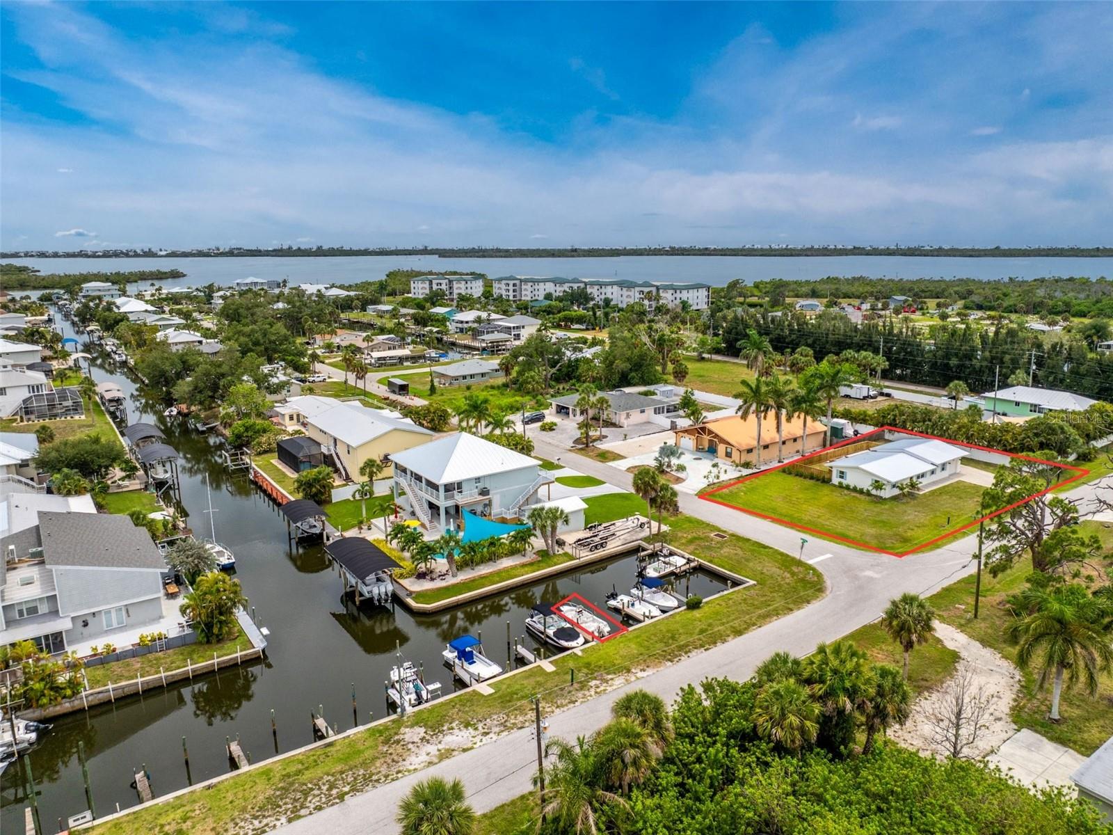 From Morning Boat Rides to Sunset Poolside Evenings, this Beautifully Renovated Coastal Retreat Delivers the Florida Lifestyle You've Been Dreaming Of. Nestled on an oversized 0.30-acre corner lot, this move-in ready 2-bedroom, 1-bath home with a 1-car garage combines modern updates, inviting indoor and outdoor living spaces, a private pool installed in 2025, and boating convenience with a dedicated boat slip. The exterior welcomes you with a 2025 metal roof, charming shutters, a beautiful wood entry door, and an oversized corner lot with plenty of room to park your boat or RV, accented by tropical landscaping and mature palms. Inside, you'll love the cohesive blonde luxury vinyl plank flooring that runs throughout the home, impact windows, and a versatile floor plan offering both a living room or formal dining area and family room. The spacious family room features vaulted ceilings, a fireplace, and triple sliding glass doors that open directly to the pool area. The kitchen features quartz countertops and matching backsplash, solid wood white shaker-style cabinetry with under cabinet lighting, a closet pantry, breakfast bar, and newer Bosch stainless steel appliances. Both bedrooms are generously sized, with one offering a walk-in closet and the other a reach-in closet. The beautifully updated bathroom features a dual-sink quartz vanity and a large walk-in shower with dual shower heads, a built-in niche, and frameless European-style glass doors. Whether you're hosting friends or relaxing after a day on the water, the pool area offers a spacious paver deck with plenty of room for dining and lounging, while the pool's sun shelf is perfect for enjoying the Florida sunshine. A matching wood fence surrounds the pool area, and recently planted pitch apple hedges will continue to enhance privacy as they mature. Your dedicated boat slip is just a short distance from the home, providing convenient access to Lemon Bay and the Gulf beyond. Spend your days exploring nearby sandbars, fishing local waters, visiting Boca Grande and Palm Island, or cruising to waterfront restaurants and tiki bars. Ideally located in the Pine Cove section of Placida, you'll enjoy easy access to beaches, marinas, golf, shopping, and dining. With a fully renovated interior, private pool, oversized lot, and boating access, this property offers everything needed to embrace the Southwest Florida lifestyle. Come experience the perfect blend of comfort, convenience, and coastal living at 8153 Robert Street in Placida.