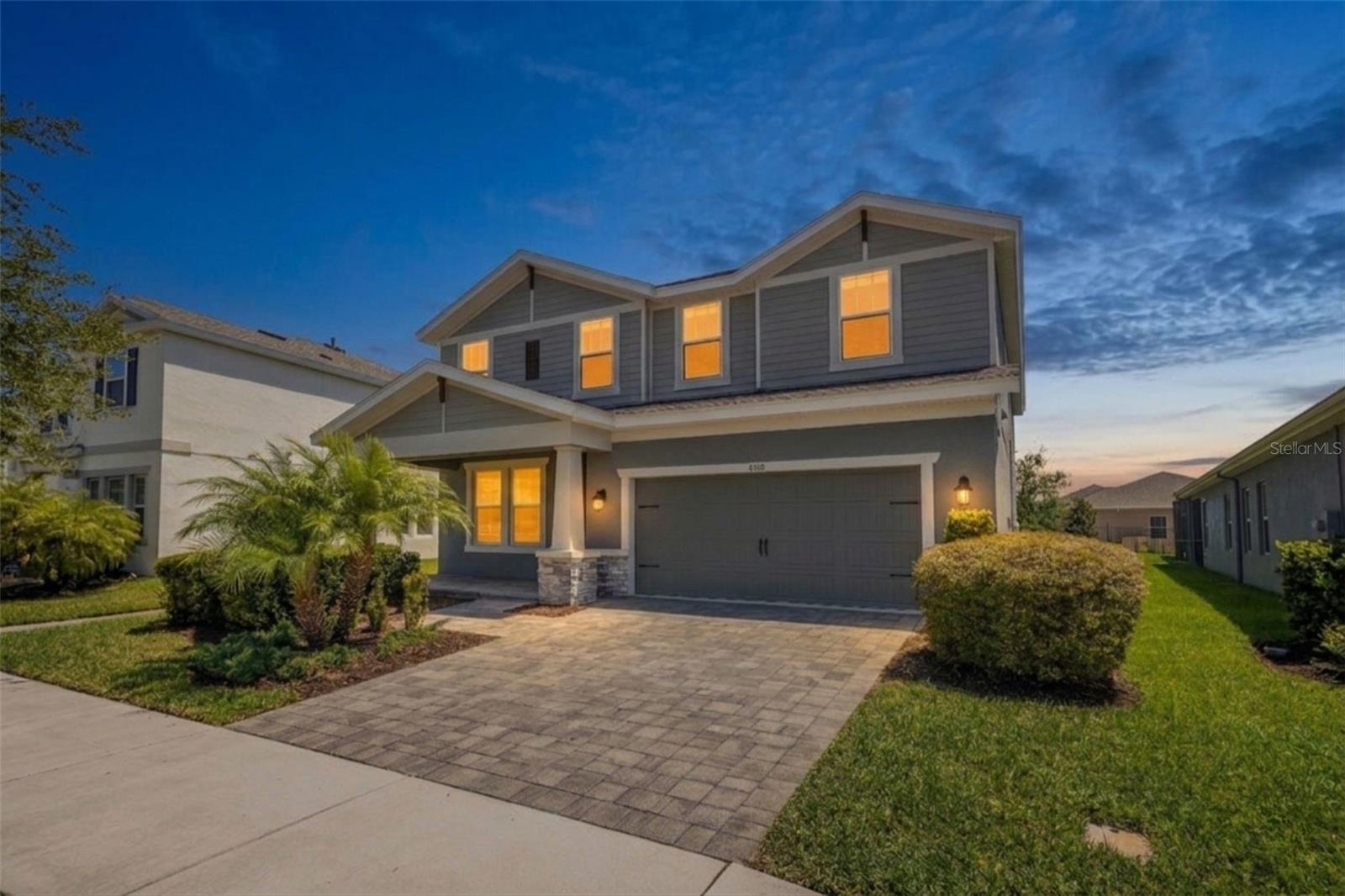 Located in the heart of Bexley and just a short walk from highly rated Bexley Elementary School, this 5-bedroom, 3-bathroom Avocet II floor plan by Homes by WestBay offers the space, flexibility, and community lifestyle buyers are looking for in one of Pasco County’s most popular neighborhoods. With 3,336 square feet, a 3-car tandem garage, a private enclosed office, a first-floor guest suite, and a massive upstairs loft, the layout is designed to adapt to everyday living, entertaining, working from home, and hosting overnight guests.

From the moment you arrive, the curb appeal stands out with a paver driveway and an oversized covered front porch with plenty of room for outdoor seating. Inside, wood-look tile flooring flows through the main living areas, creating a clean, cohesive feel. Just off the entry, French doors open to a large enclosed office featuring luxury vinyl plank flooring and smart lighting, making it ideal for working from home, studying, or creating a flexible bonus space.

Continue through the home to the open-concept kitchen, dining, and living area, designed for both everyday living and entertaining. The kitchen is a true centerpiece with quartz countertops, dark cabinetry, a designer backsplash, stylish lighting, stainless steel appliances, a gas cooktop with range hood, and a smart refrigerator. The kitchen connects seamlessly to the dining and living spaces, each enhanced by upgraded light fixtures and plenty of natural light. Just off the dining area, a full bedroom and bathroom create an excellent option for guests, in-laws, or multigenerational living.

Sliding glass doors from the living room lead to a screened rear porch, giving you a comfortable outdoor space to relax and enjoy the Florida lifestyle. Upstairs, the home continues to impress with a huge 25’ x 20’ loft that can serve as a media room, game room, playroom, home gym, or second living area. Three additional bedrooms, all with luxury vinyl plank flooring, share a full bathroom with dual sinks and a tub/shower combination.

The spacious primary suite is tucked away upstairs and spans more than 21 feet in length, offering smart lighting, plenty of room for a sitting area, and a well-appointed en-suite bathroom with dual sinks, a walk-in shower, and a large walk-in closet. The laundry room is conveniently located just outside the primary suite for added everyday convenience.

Living in Bexley means enjoying some of the best amenities in Land O’ Lakes, including a clubhouse with an on-site café, multiple pools, playgrounds, a fitness center, walking and biking trails, dog parks, and the HUB at Bexley with shopping, dining, and everyday conveniences. With easy access to SR 54 and the Veterans Expressway, this location offers a quick connection to Tampa, the airport, beaches, restaurants, and everything the Tampa Bay area has to offer.