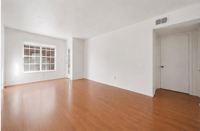 Virtually Staged. Welcome to this move in ready, one bedroom unit in the Vantage Point Community. Step inside to an open space floor plan layout featuring warm wood-style flooring, an abundance of natural light, and a seamless flow between the living, dining, kitchen, and balcony areas—ideal for everyday living or guest-friendly use. The kitchen is efficiently designed with ample cabinetry and a convenient breakfast bar overlooking the main living space, supporting both casual dining and easy entertaining. Neutral finishes throughout create a light feel and allow for simple personalization. The bathroom showcases a modern vanity with solid-surface countertop, contemporary fixtures, and a tiled accent wall, paired with a full tub/shower combination. In-unit laundry adds everyday convenience and enhances long-term rental functionality. With a flexible floor plan, durable finishes, and low-maintenance design, this property is well-positioned as a primary residence, seasonal home, or income-producing rental. Vantage Point Condominiums is a gated, 32-acre community offering resort-style amenities including a large swimming pool and spa, fitness center, tennis courts, clubhouse, walking paths, lakes, and picnic/grill areas, with many units featuring balconies, lake views, and in-unit washers and dryers. The community is pet-friendly and designed for comfortable, low-maintenance living with on-site management and maintenance. Its prime location provides quick access to both downtown St. Petersburg and Tampa Bay via the Gandy Bridge and I-275. Nearby attractions include Derby Lane Greyhound track, Weedon Island Preserve, downtown St. Pete’s waterfront and museums, the St. Pete Pier, and very easy drives to all Tampa Bay beaches, shopping, and major airports.