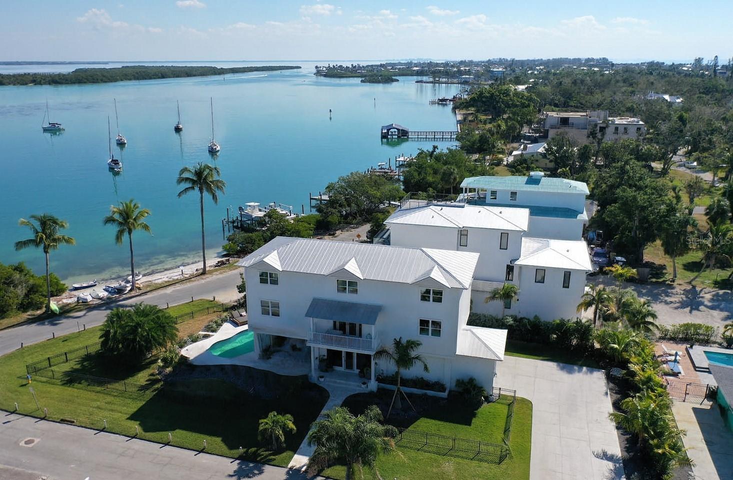 For Sold Data only - Waterfront luxury meets bespoke designer finishes in this newly remodeled coastal retreat overlooking Sarasota Bay. Thoughtfully reimagined over the past year, this elevated residence captures sweeping bay views from every level, creating a seamless connection between refined interiors and the surrounding natural beauty.
The chef’s kitchen anchors the open living space, flowing effortlessly into an inviting great room with fireplace, ideal for entertaining or quiet evenings while taking in captivating views of birds, dolphins, and ever changing skies across the water. Mornings begin with brilliant sunrises over the scenic anchorage, followed by the simple pleasure of launching a kayak directly from the sandy beach just moments from your door.
Outdoor living beckons with a newly designed pool and spa complemented by a spacious covered terrace, offering an ideal setting for relaxation or hosting memorable gatherings. Inside, the residence features four comfortable bedrooms, extra space for office or den use on each level, an elevator, and private terraces on three distinct levels, providing both convenience and a sense of retreat for family and guests alike. High end appliances, custom cabinetry, wide plank flooring, impact rated windows and doors, and new mechanical systems deliver modern luxury with peace of mind.
The primary suite is a true sanctuary, highlighted by a magazine worthy custom bathroom showcasing refined materials and timeless design. Every element of this exceptional home reflects a thoughtful commitment to elevated waterfront living, where comfort, elegance, and breathtaking surroundings come together in perfect harmony.