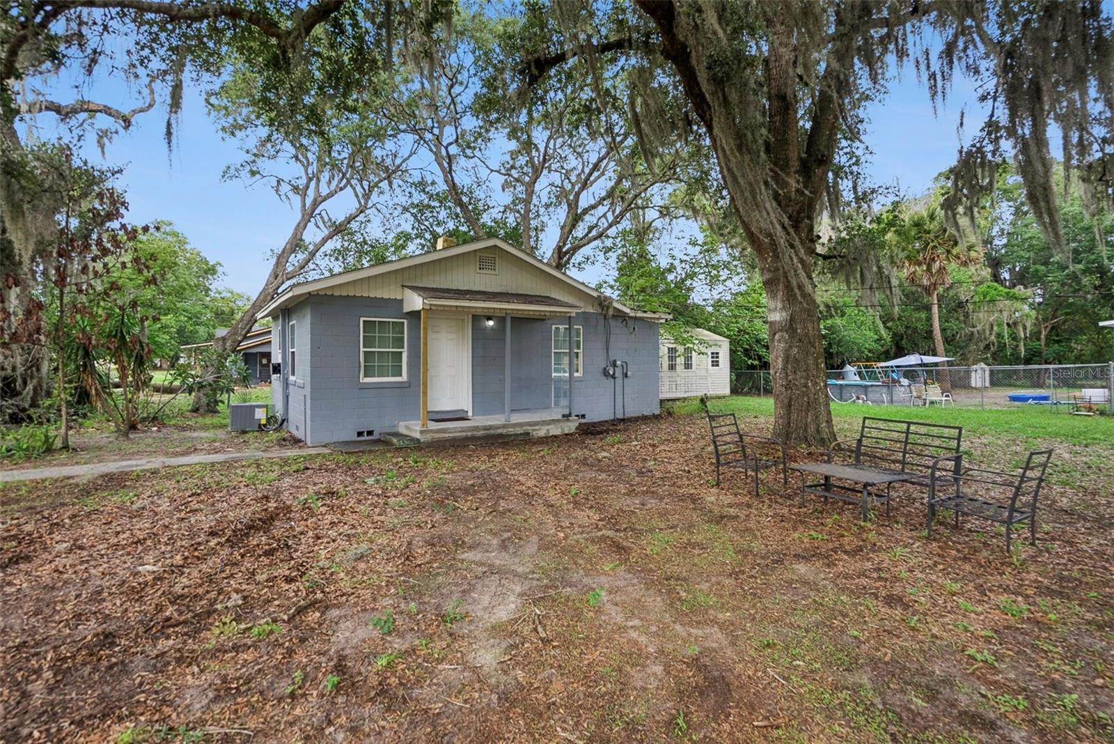 Virtually Staged. Charming and updated 2-bedroom, 1 full bath, 1 half bath bungalow situated on a large corner lot just minutes from historic Downtown DeLand, Stetson University, shopping, dining, and local parks. Whether you're looking for an investment property, your first home, or a convenient residence for a college student, this property offers incredible flexibility and value. Inside, you'll find an updated kitchen featuring newer stainless steel appliances (2025), spacious living areas, a walk-in closet, and both bedrooms have direct bathroom access, providing added convenience and functionality. Major updates include a newer roof (2021) and a brand-new HVAC system (2026), offering peace of mind for years to come. Located within DeLand's Historic District and positioned in a Qualified Opportunity Zone (QOZ), this property presents an exceptional opportunity for investors seeking to expand their rental portfolio or capitalize on future growth potential. With a renter already in place, it may offer immediate income-producing possibilities. Enjoy easy access to Downtown DeLand's vibrant shops, restaurants, and community events while being just minutes from campus. Don't miss this chance to own a well-maintained home in one of Central Florida's most charming and historic communities.